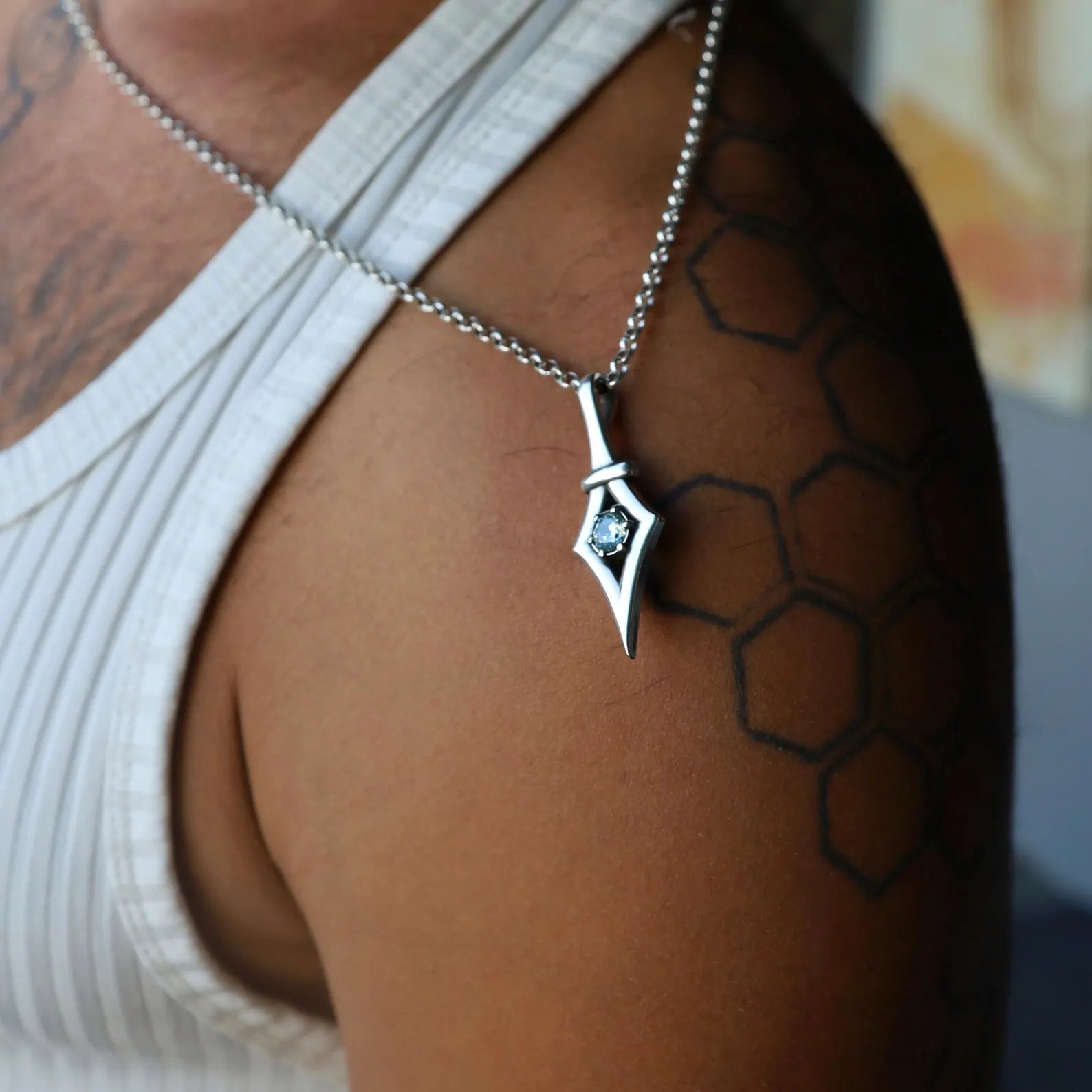 Elegant handmade sterling silver necklace featuring a gothic aquamarine pendant. With its minimalist design and artisan craftsmanship, this necklace makes a striking March birthstone jewelry piece. A thoughtful gift for women who appreciate edgy, alternative fashion and meaningful gemstone jewelry.