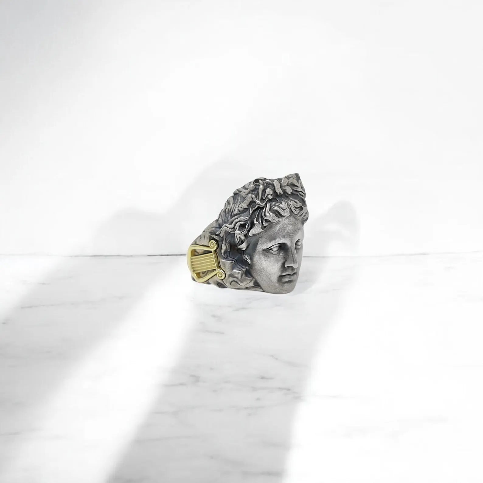From the side, this handcrafted Greek ring reveals every detail of its artisan precision. The 23mm diameter and 2.5mm thick band ensure a balanced weight and strong presence on your hand. The sculpted form of Apollo is raised with elegance, giving the ring a museum-quality appearance that stands out in both casual and formal styles. A fusion of mythology, power, and fine craftsmanship in wearable art form.