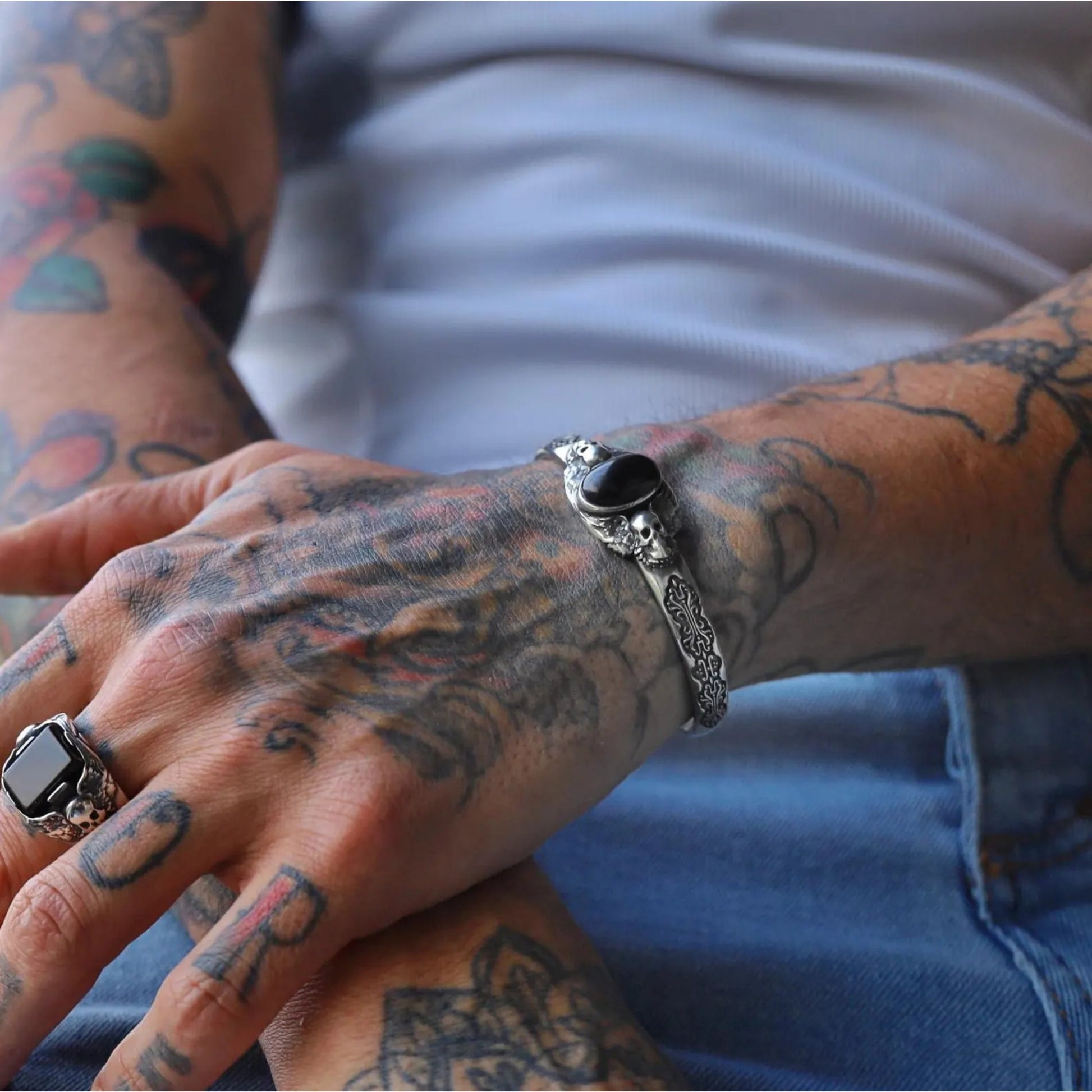 Oxidized silver bracelet with gothic skull engravings and a natural black onyx gemstone, handcrafted for men. Its unique blend of luxury and rebellion makes it perfect for gothic, biker, or medieval-inspired fashion styles.