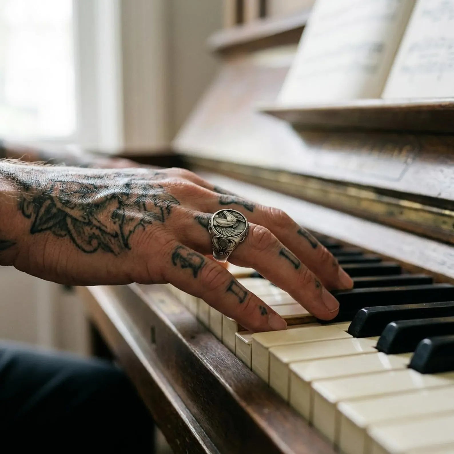 Side angle view of winged horse statement ring for men, showcasing thick 22mm band width and detailed artisan carving in handcrafted sterling silver