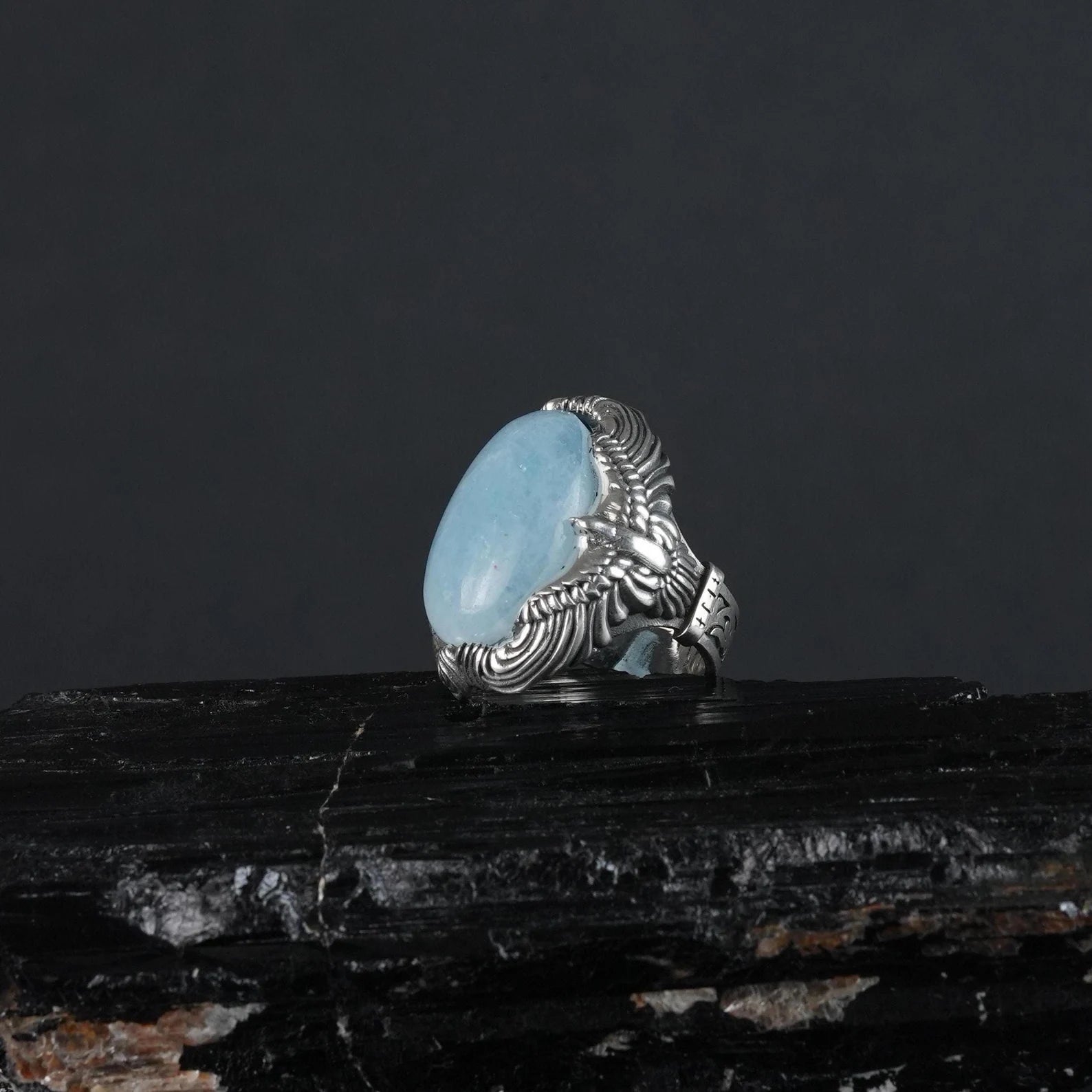 This bold ring caters to women who embrace nature-inspired fashion. The sterling silver band, adorned with a detailed eagle and calming aquamarine, adds a touch of serenity and elegance to any outfit. Perfect for daily wear or special occasions.
