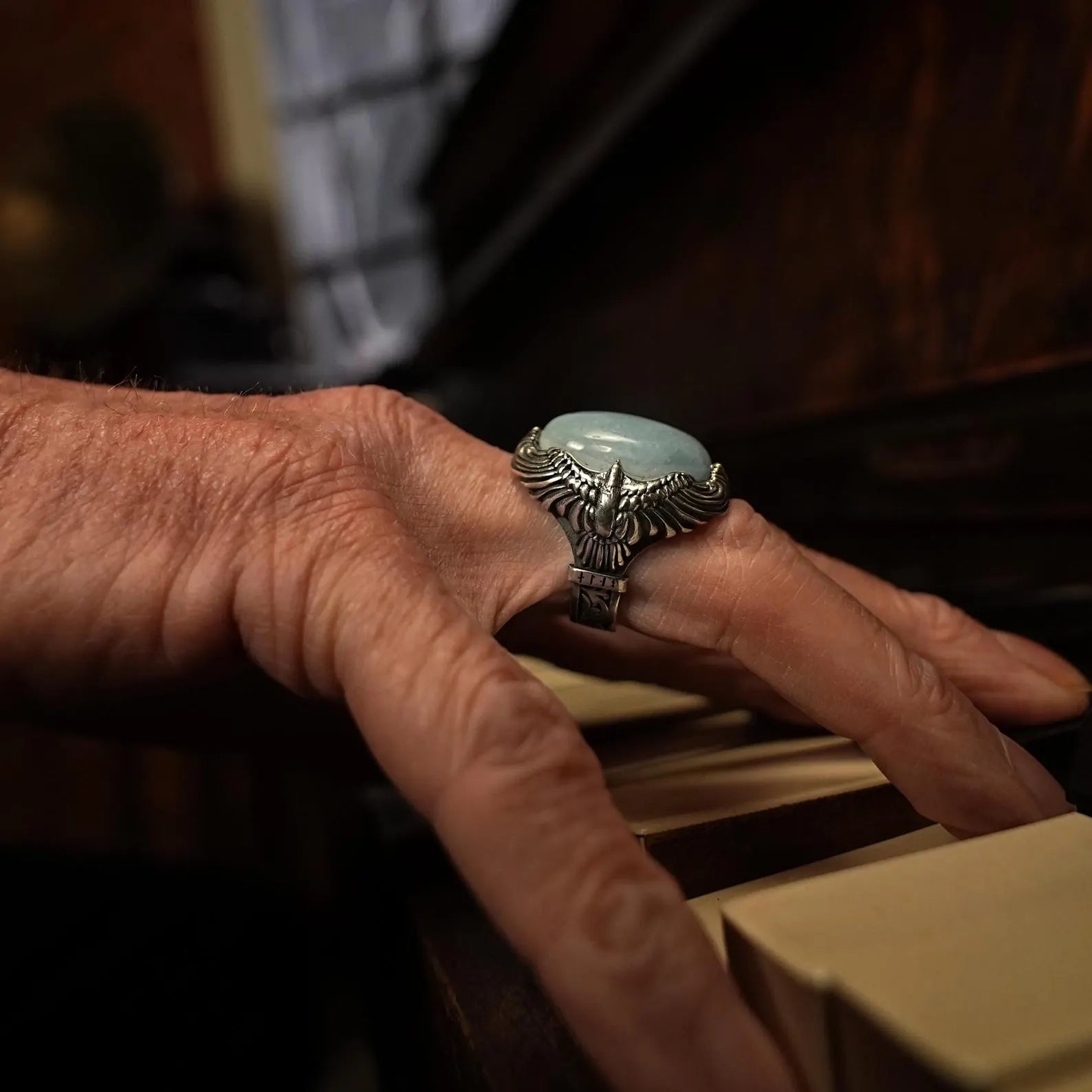 Designed for both men and women, this unisex ring features a bold eagle design adorned with a serene aquamarine stone. The handcrafted sterling silver band ensures durability and comfort, making it suitable for daily wear or special occasions.
