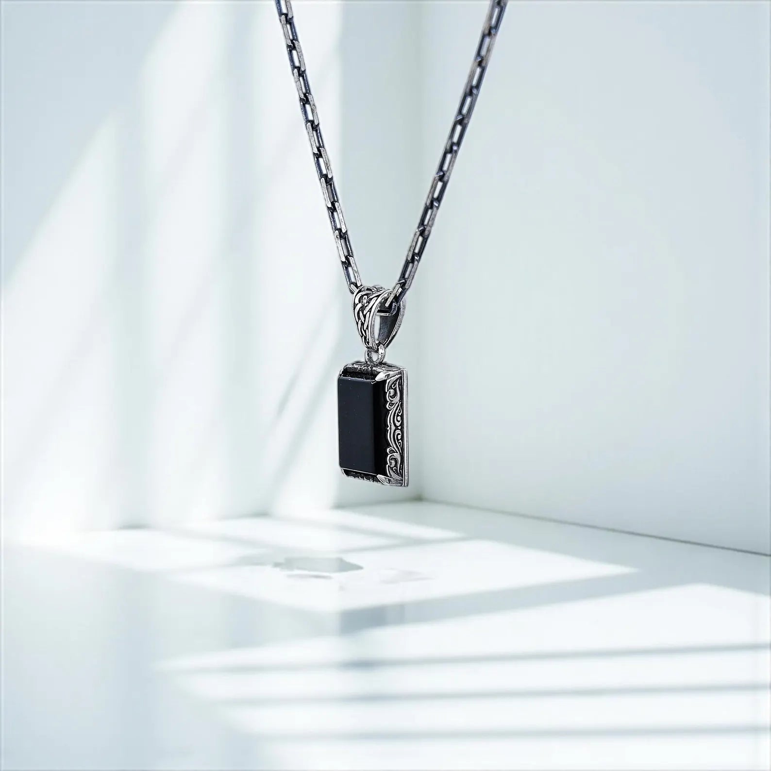 Sterling silver fantasy-inspired necklace with polished black onyx pendant. Perfect for men seeking a personal talisman or daily accessory with vintage elegance, this piece brings both grounding energy and refined style together in one unique design.