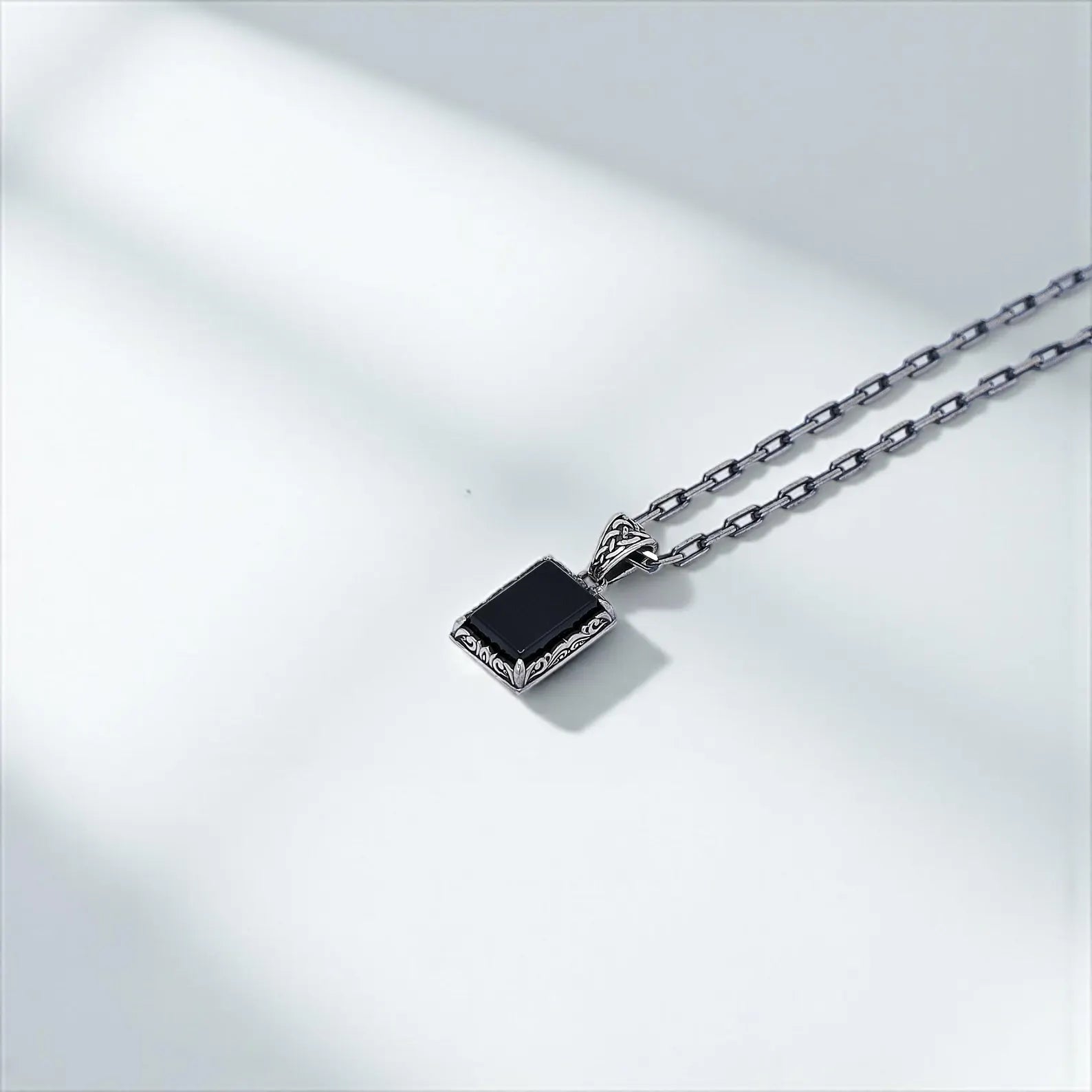 Elegant mens pendant necklace in 925 sterling silver with a striking black onyx gemstone. The detailed craftsmanship and vintage aesthetic evoke gothic charm and personal power, making it a meaningful accessory for spiritual men or lovers of refined, symbolic jewelry.