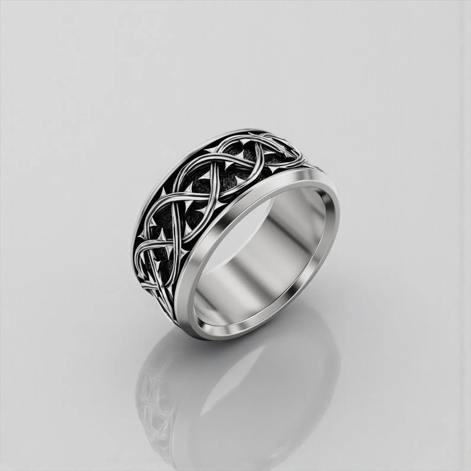 Close-up macro image of a solid 925 sterling silver thorn crown ring, emphasizing engraved thorn patterns, handcrafted precision, and oxidized finish inspired by Christian symbolism