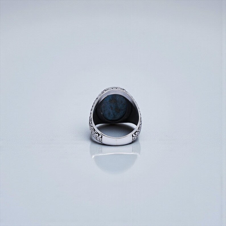 Handmade sterling silver signet ring with natural turquoise gemstone, designed with classic Baroque floral motifs and strong masculine proportions