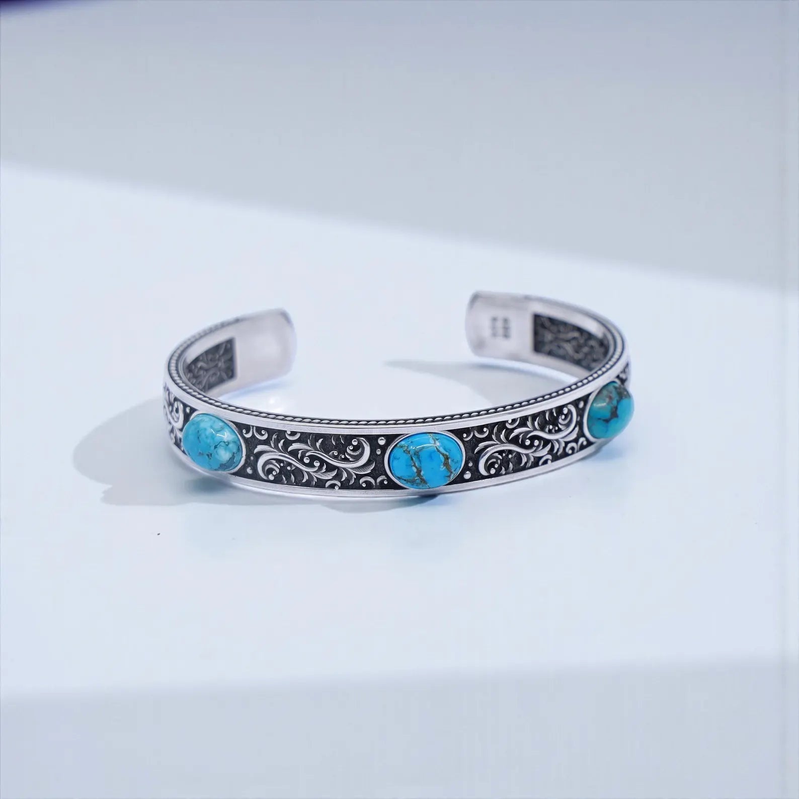 Men’s 925 sterling silver turquoise cuff bracelet with triple turquoise stones, detailed Southwestern engraved patterns, and an oxidized vintage Western finish. Adjustable bold statement cuff for lovers of rustic, handcrafted, artisan silver gemstone jewelry.