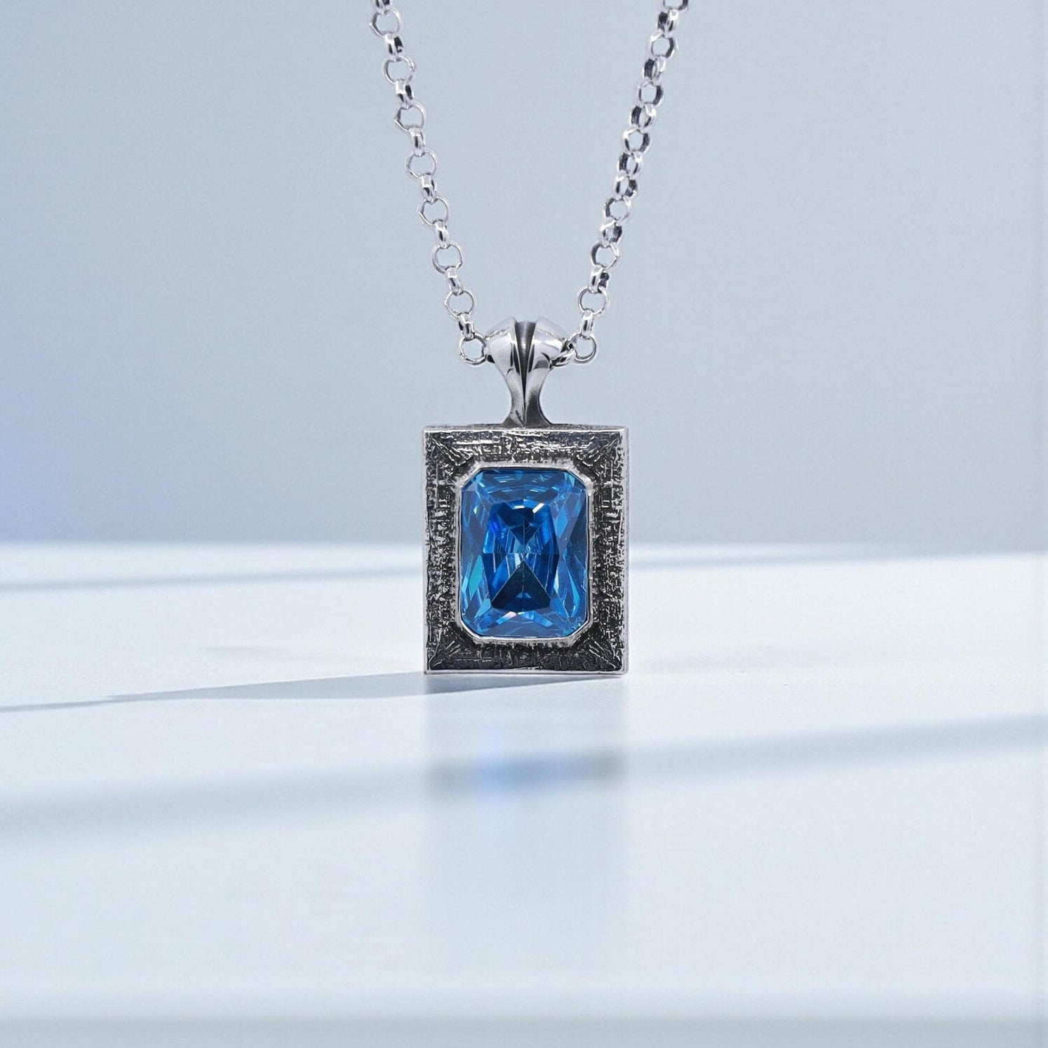 Handcrafted 925 sterling silver emerald cut blue topaz pendant necklace featuring a vibrant blue gemstone with a minimalist, vintage-inspired design. Oxidized and hand-polished finish creates a luxurious statement piece, ideal as a personalized anniversary gift, Christmas gift, or birthday present for men