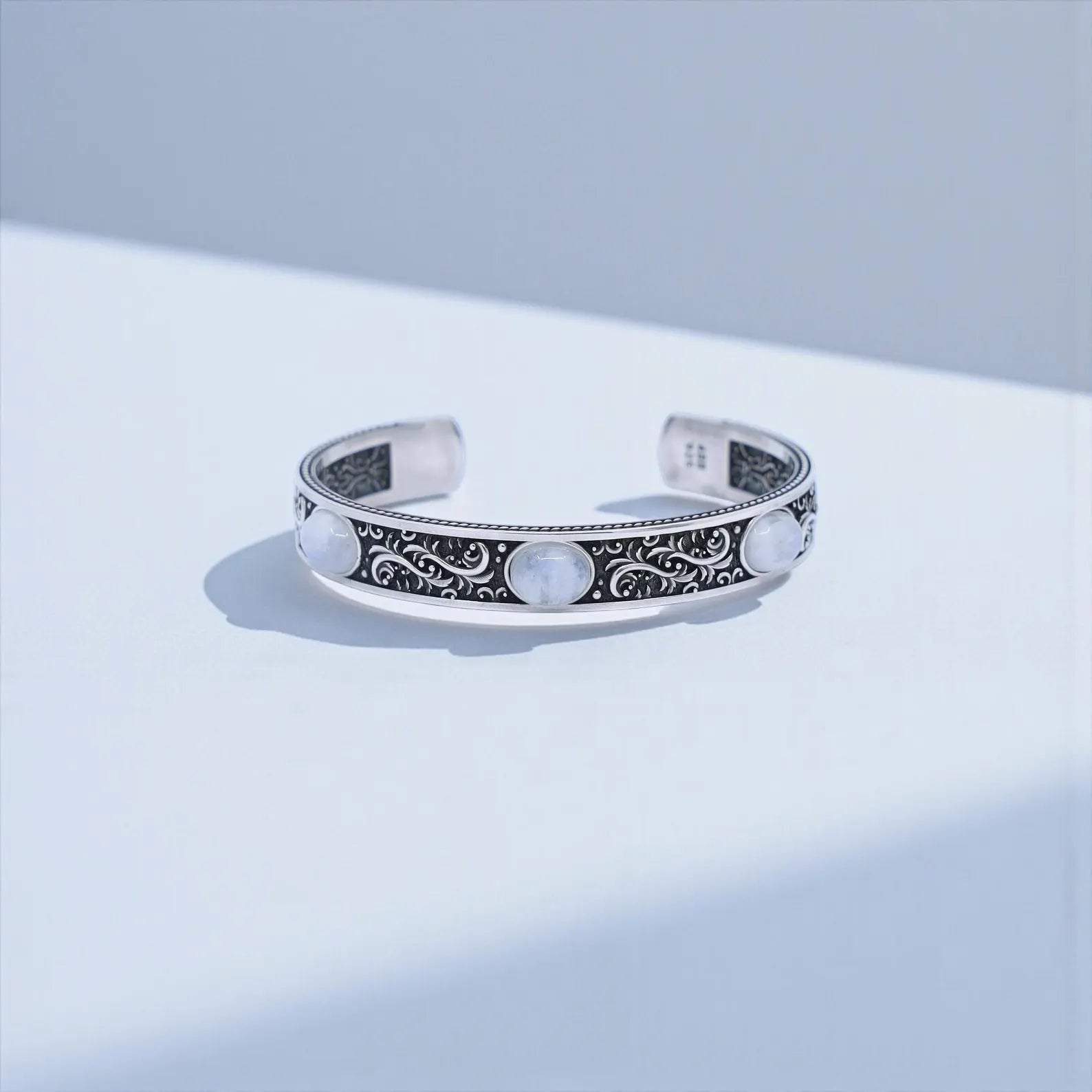 Vintage-inspired moonstone men’s cuff bracelet made from high-quality 925 silver, showcasing detailed Baroque patterns and glowing moonstone stones. Adjustable bold design ideal for spiritual, protective, and meaningful gifts.