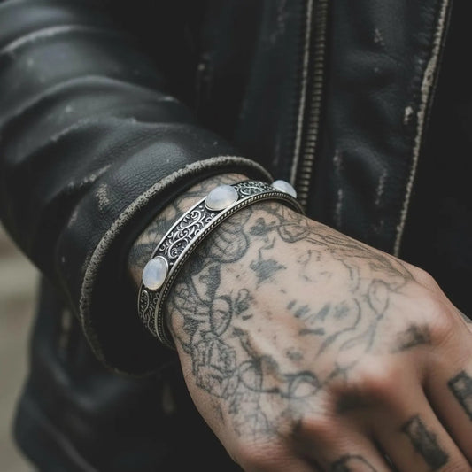 Sterling silver moonstone cuff bracelet with intricate Baroque engravings and three luminous moonstone cabochons. A chunky biker-style men’s bracelet crafted by hand, perfect for gifting or everyday statement wear.
