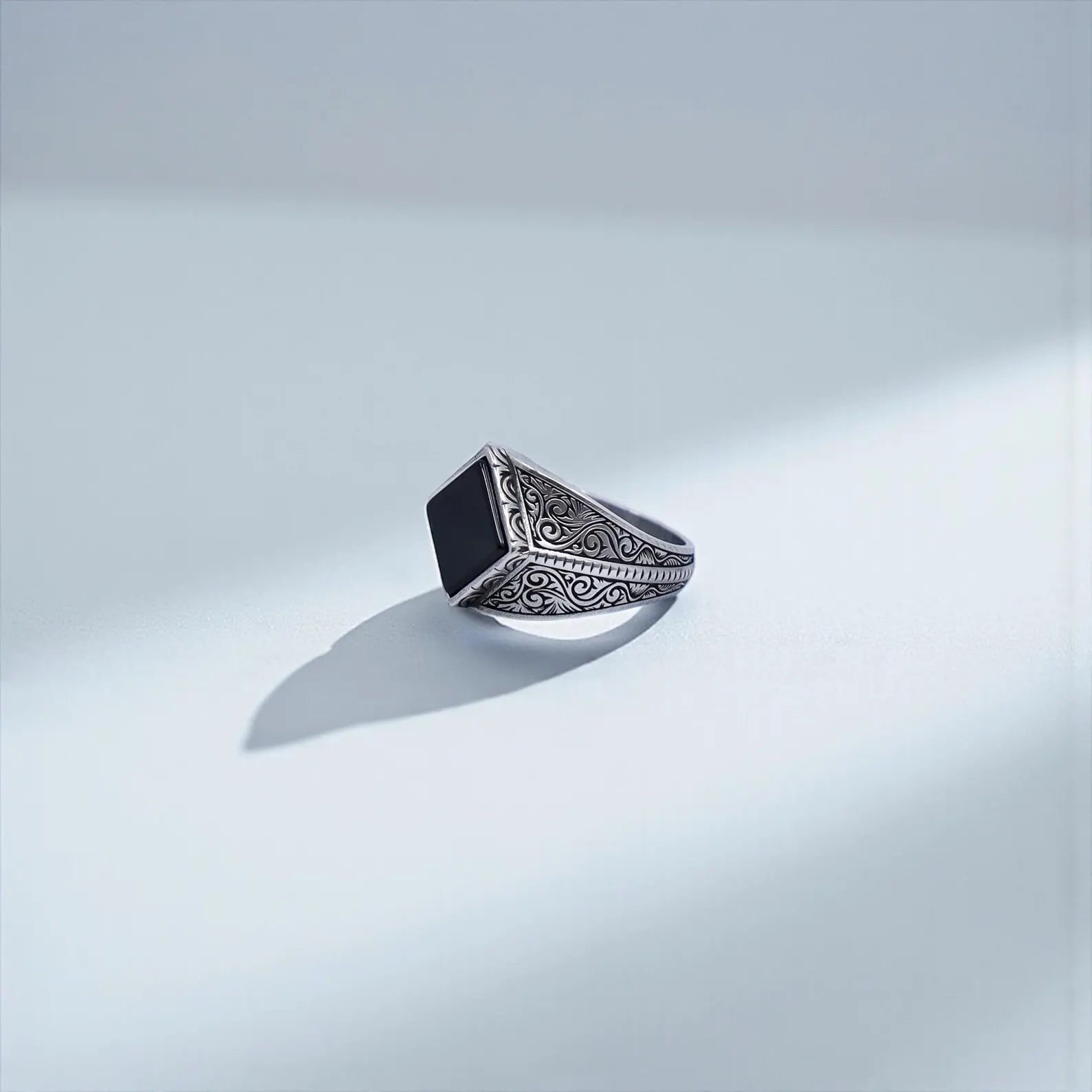 Detailed shot of the 925 sterling silver black onyx ring highlighting the oxidized finish, baroque engravings, and square natural onyx stone, optimized for searches like “engraved silver ring men” and “luxury black onyx jewelry.”