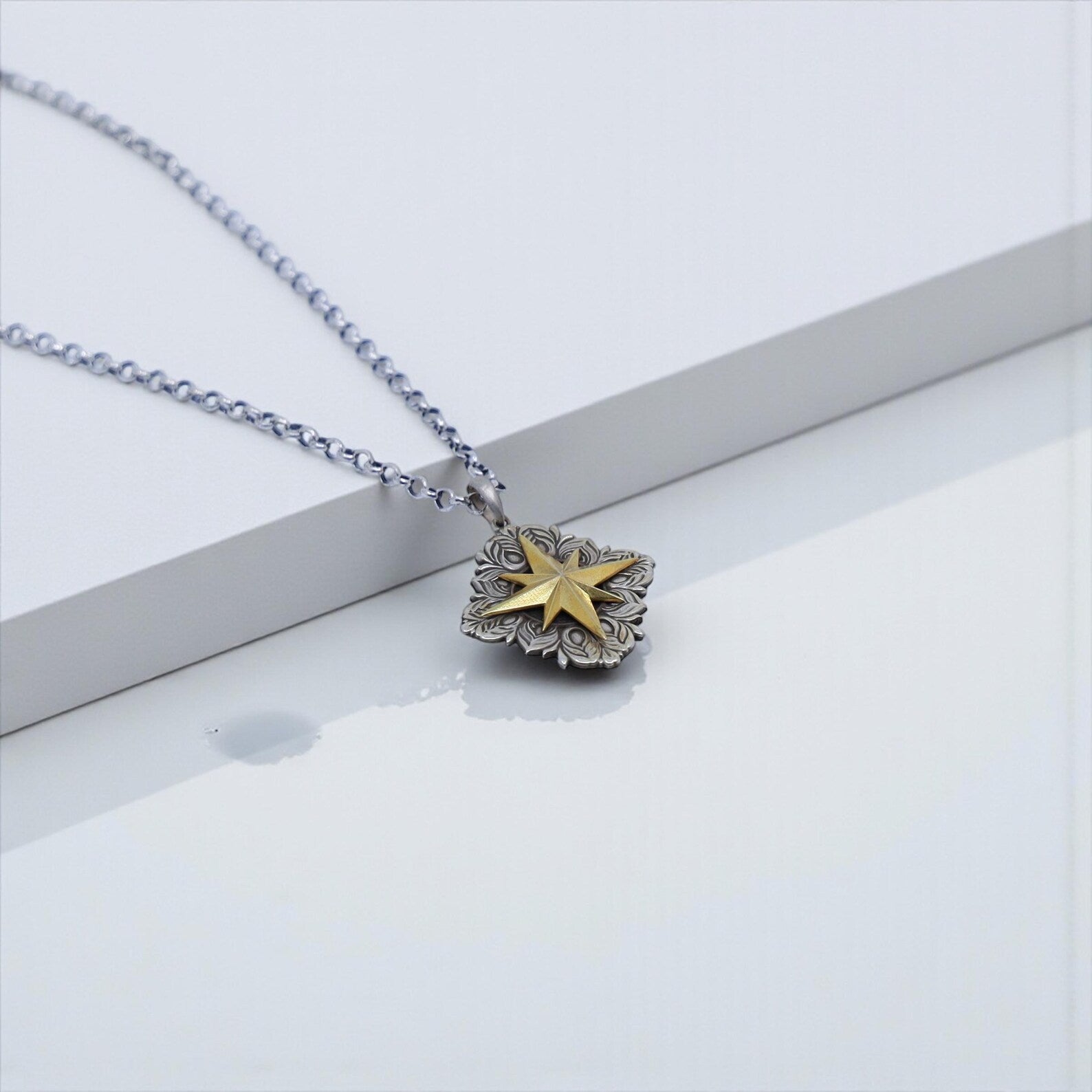 Macro image of a north star compass pendant symbolizing guidance and protection, crafted from 925 sterling silver with gold plating—perfect for keywords such as meaningful necklace for him, travelers gift, and adventure jewelry men.