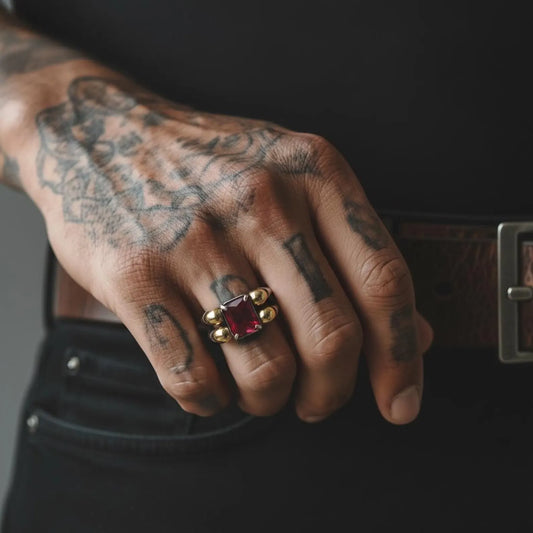 Artistic angled shot of a 925 sterling silver skull ring with emerald stone, highlighting engraved gothic features, gold-plated accents, and a powerful masculine aesthetic—ideal for men’s gothic rings, dark fashion jewelry, and unique emerald gifts.