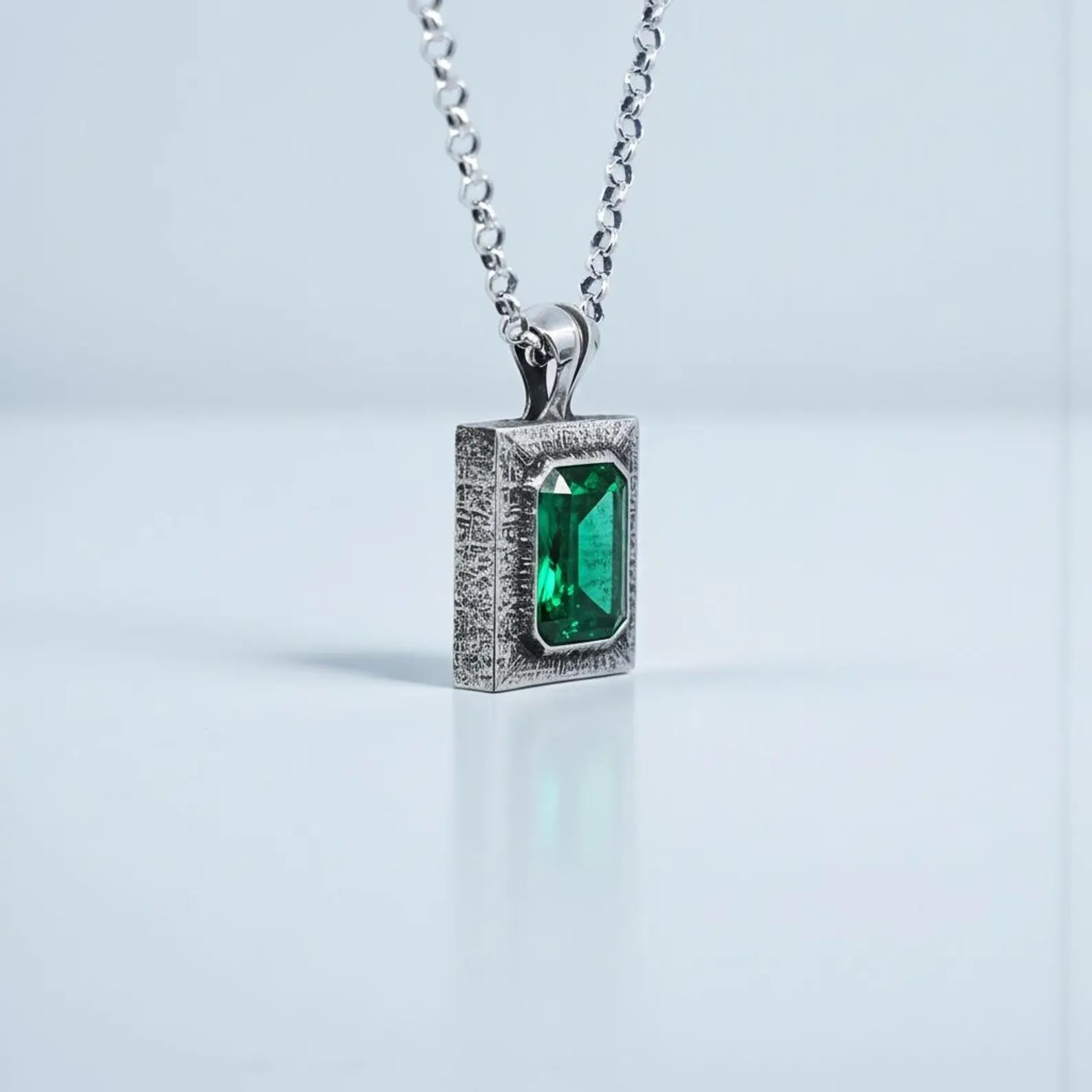 High-quality sterling silver emerald gemstone necklace with bold statement pendant, handcrafted for men seeking unique spiritual jewelry with deep green stone energy and luxury finishing.