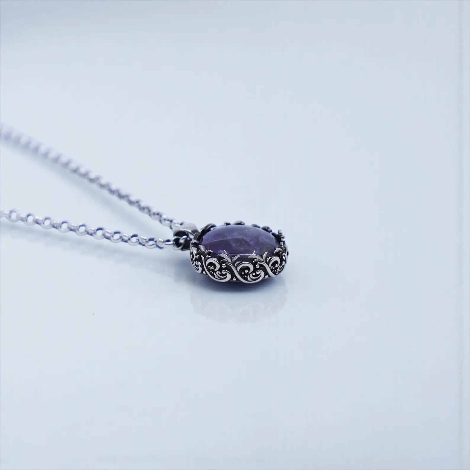 Macro image of statement amethyst pendant crafted in 925 sterling silver with oxidized, hand-polished surface, showcasing a luxurious and artistic vintage jewelry style for men and women.