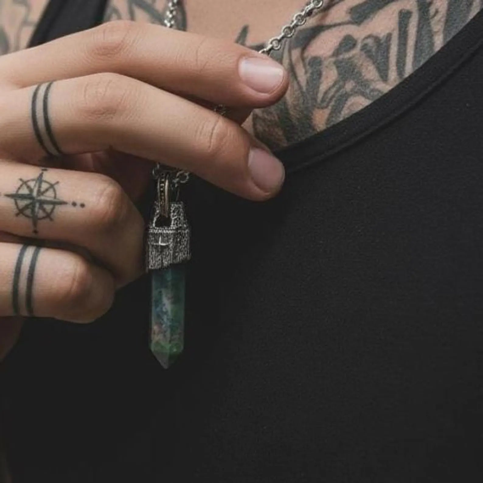 Artisanal sterling silver pendant necklace featuring a natural Moss Agate stone known for grounding and balance, designed with a vintage compass motif and hand-polished oxidized details for masculine elegance.