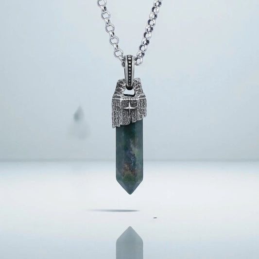 High-detail close-up of a handcrafted Moss Agate pendant necklace for men, featuring a natural green moss agate gemstone with earthy tones set in a vintage-style sterling silver compass frame, polished and oxidized for a bold nautical statement look.