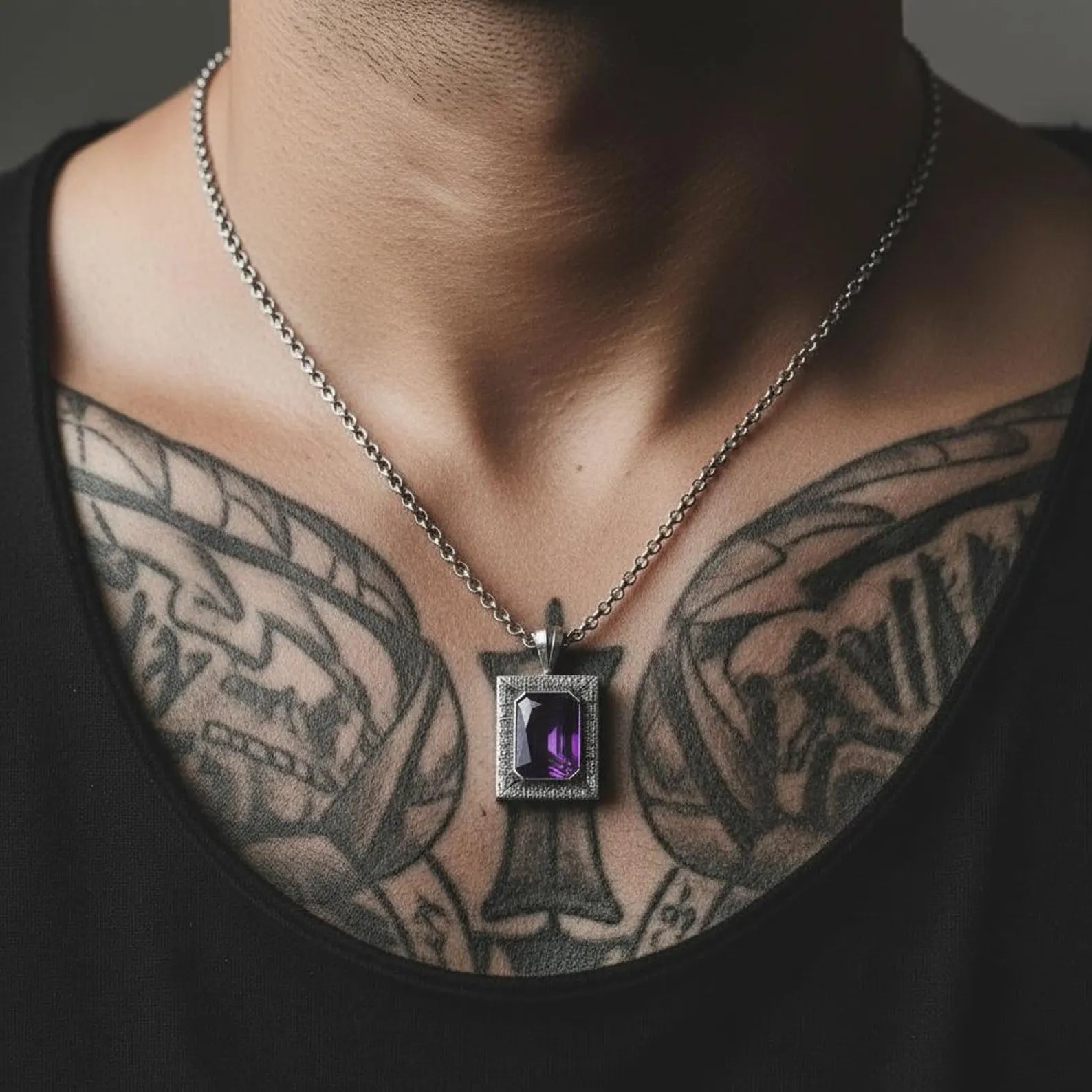 Close-up image of a customizable emerald-cut amethyst pendant in high-quality sterling silver, showcasing its polished finish, handcrafted details, and statement chunky style for men.