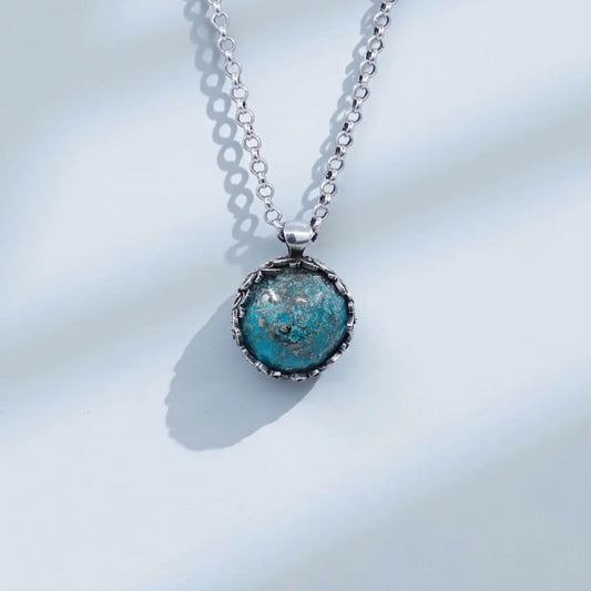 Handcrafted sterling silver turquoise gemstone pendant necklace for men featuring a large natural turquoise stone set in an ornate baroque-style vintage round frame, showcasing intricate silver leaf patterns, oxidized detailing, and artisan craftsmanship; a bold and meaningful statement jewelry piece symbolizing protection, wisdom, luck, and grounding, perfect for gifting on birthdays, anniversaries, Christmas, or special occasions.