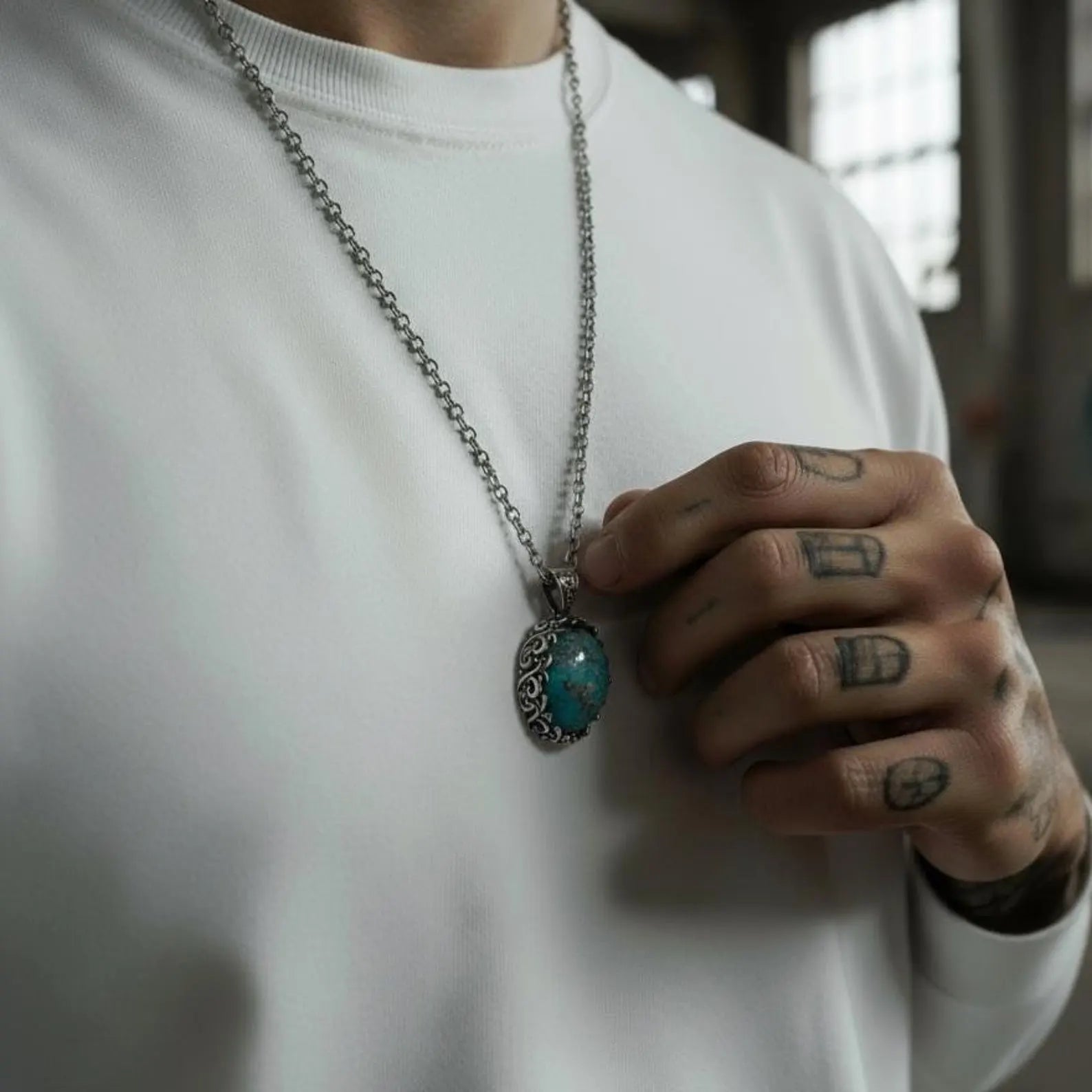 Unique natural turquoise gemstone pendant featuring a handcrafted sterling silver baroque leaf bezel with intricate scrollwork, expertly shaped and polished to highlight the rich blue hues and earthy matrix of the gemstone; an expressive men’s necklace representing ancient symbolism of protection, wisdom, and spiritual grounding.