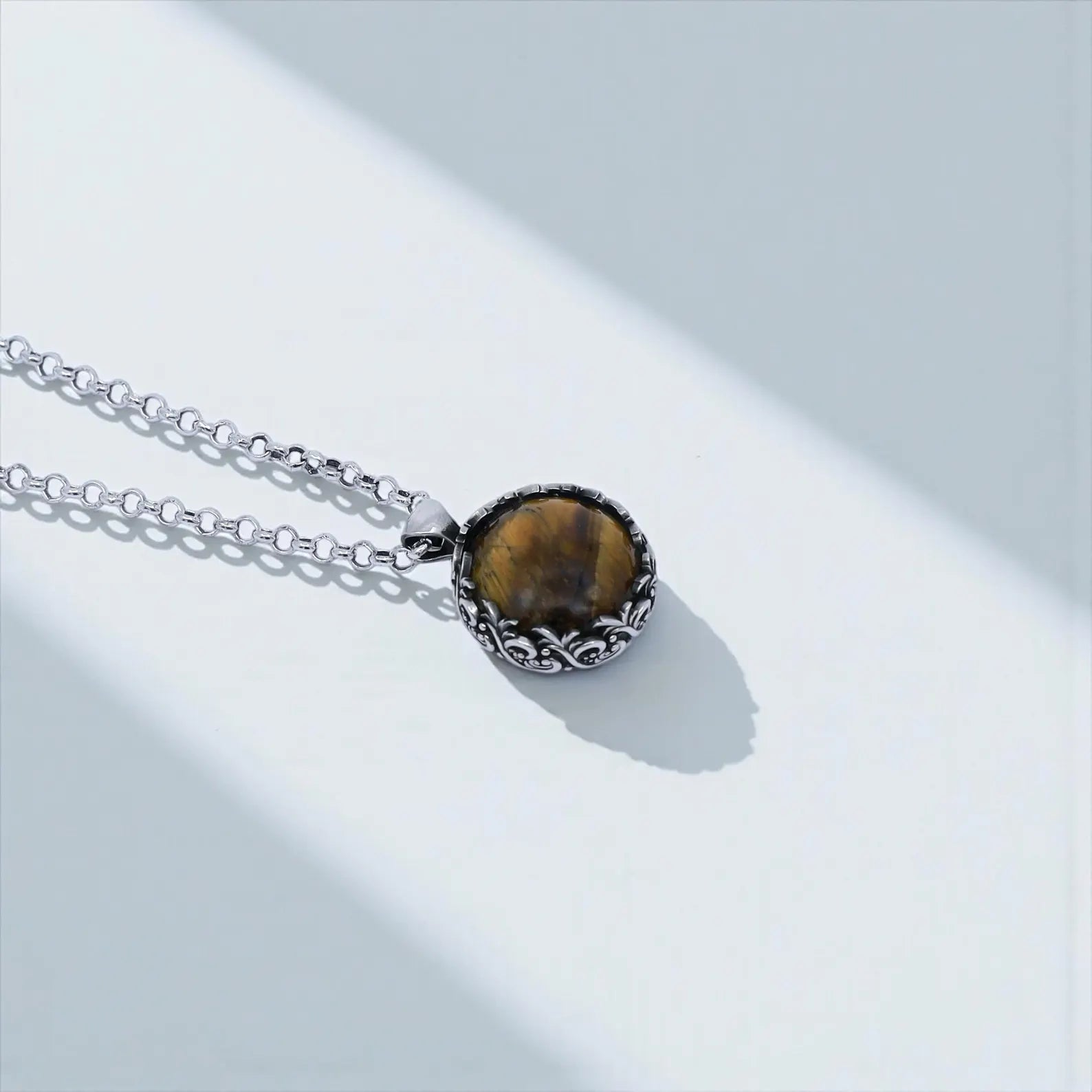 Premium unisex tiger eye pendant necklace featuring detailed baroque-style silver engravings and a natural polished gemstone, ideal for lovers of vintage, gothic, or bohemian jewelry who want a unique handcrafted accessory.