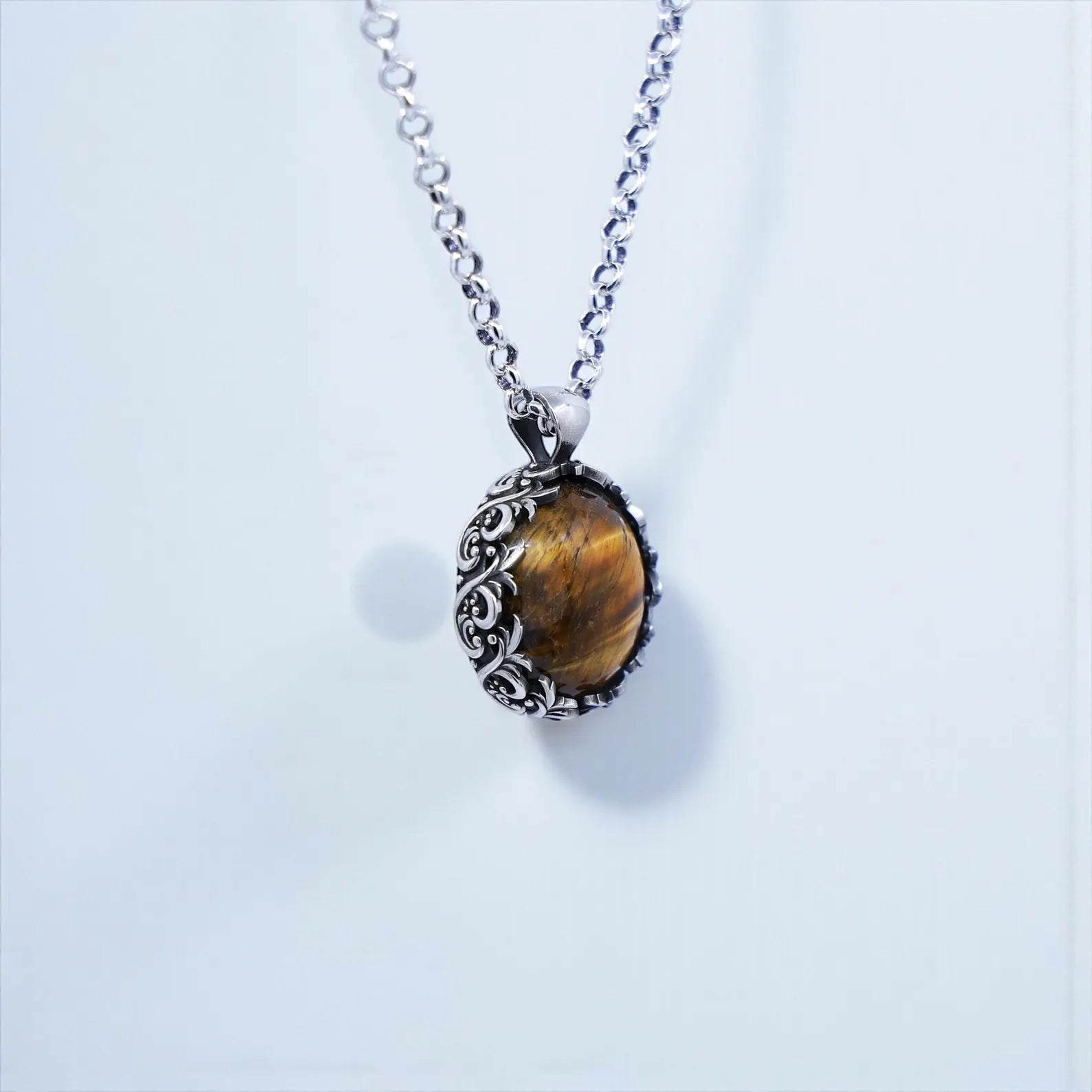 Vintage-style unisex tiger eye gemstone pendant crafted in oxidized sterling silver with detailed baroque engravings, showcasing warm golden hues and handcrafted artistry—ideal for anniversary, Christmas, or birthday gifts for men who love unique jewelry.