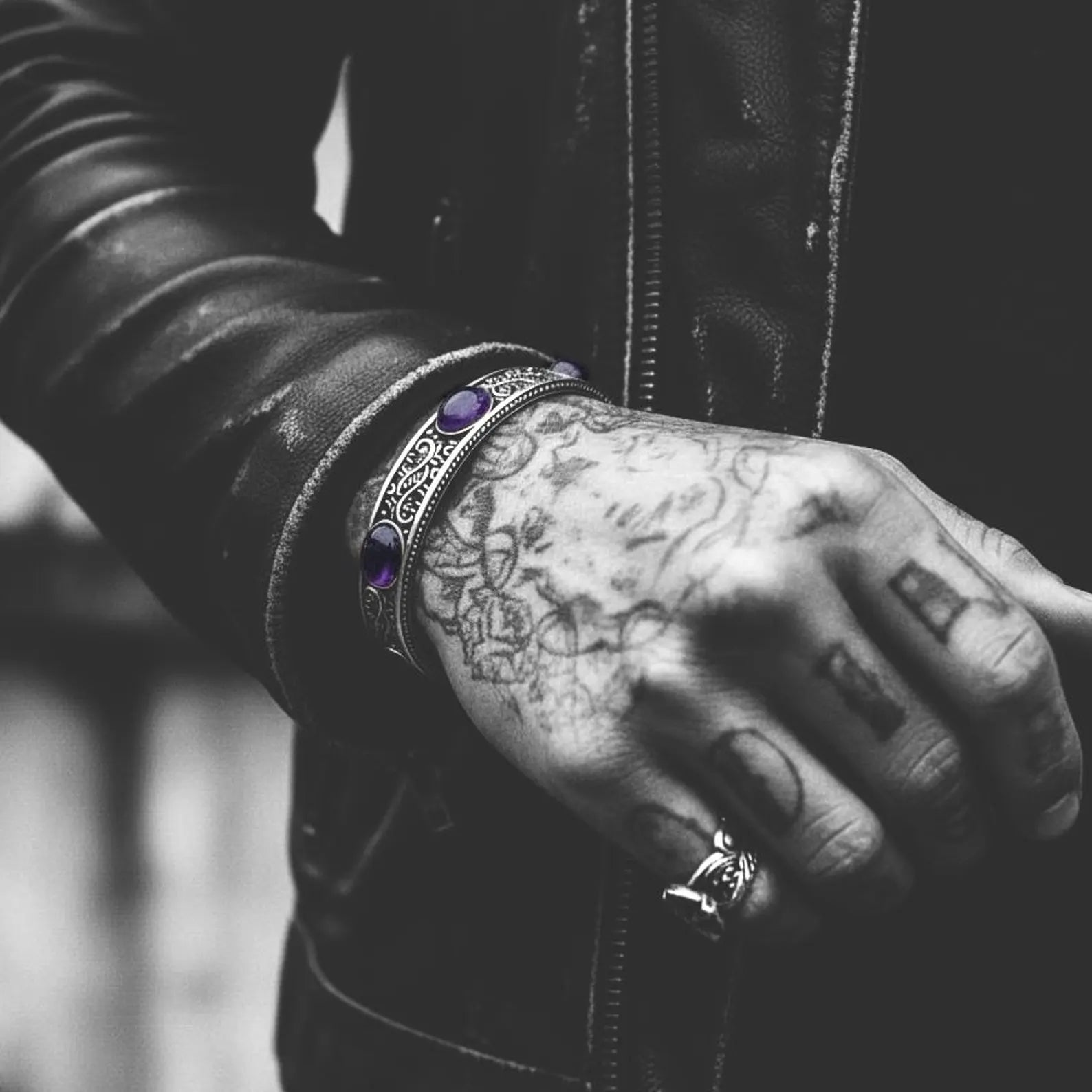 Premium sterling silver vintage-style amethyst cuff bracelet with intricate engraved details and three radiant amethyst gemstones. Weighing 40 grams and adjustable for comfort, this handcrafted statement piece is perfect for men who appreciate unique gemstone jewelry and meaningful personalized gifts.