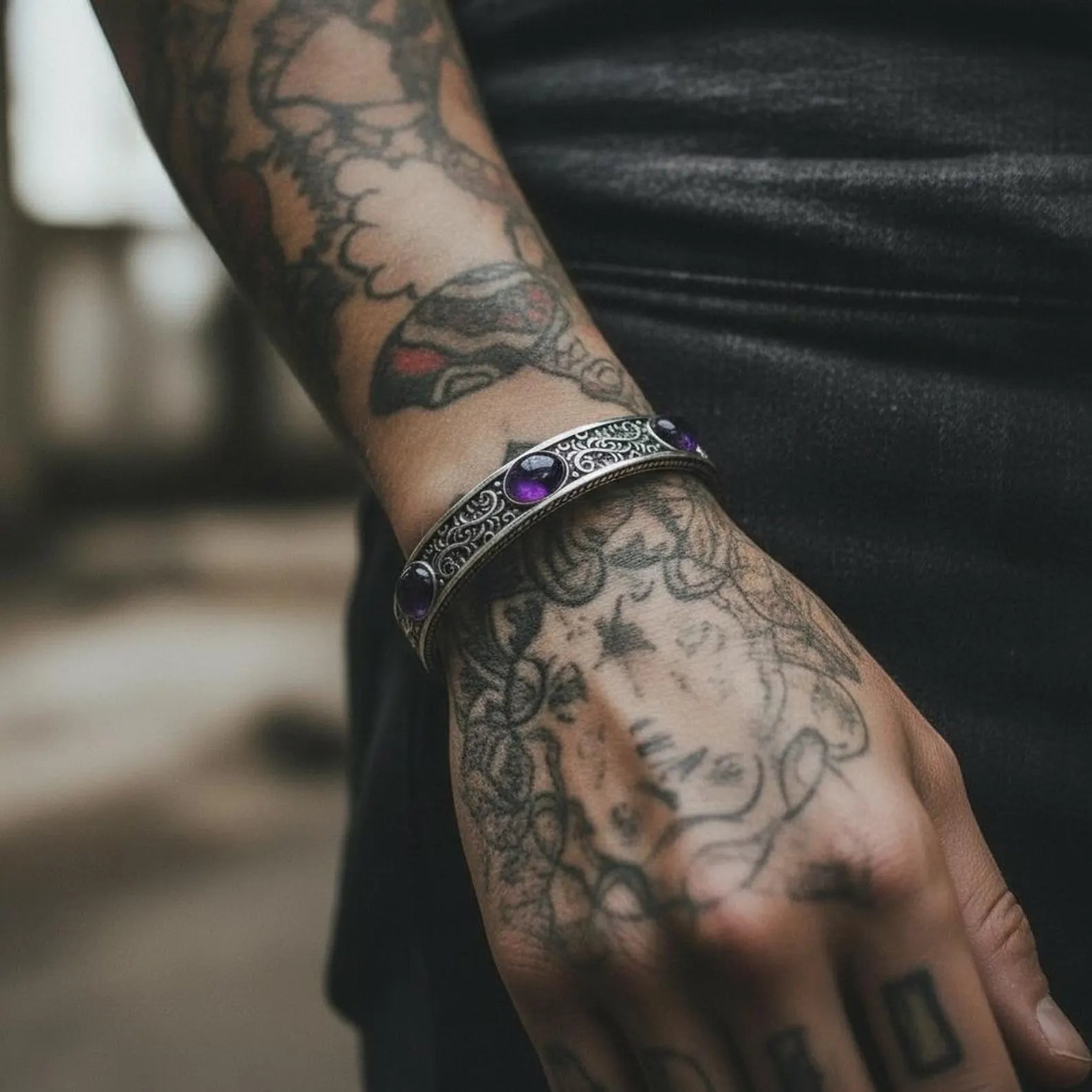 Luxury masculine amethyst cuff bracelet featuring triple natural amethyst stones mounted on a thick sterling silver band with vintage-inspired engravings, handmade for jewelry collectors who appreciate spiritual depth, bold designs, and one-of-a-kind silverwork.
