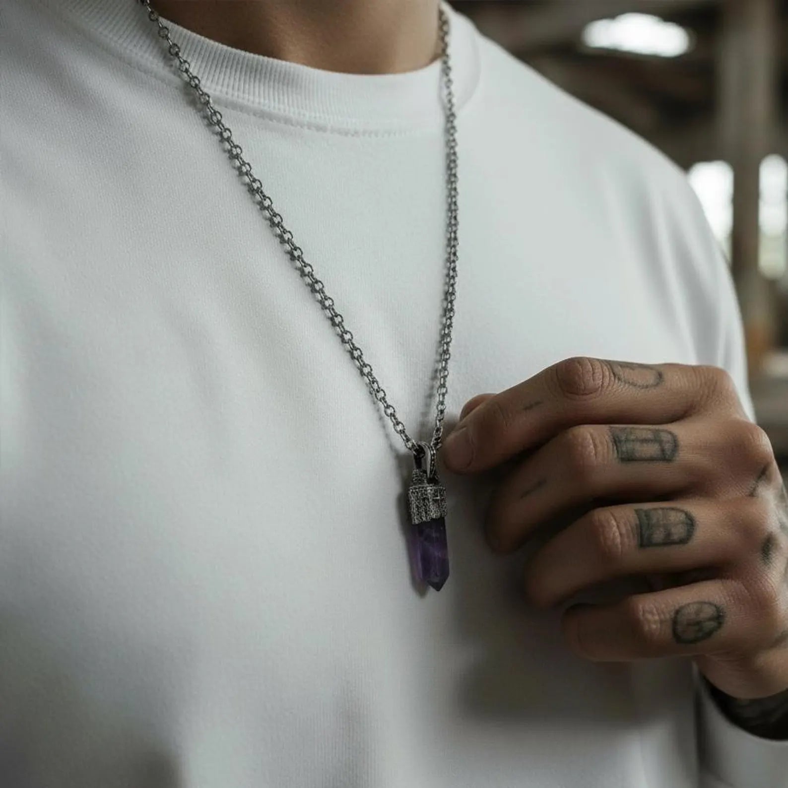 Artistic product shot of a protective amethyst talisman necklace in 925 sterling silver, designed for men with minimalist, spiritual, and statement jewelry style, featuring deep purple natural amethyst.