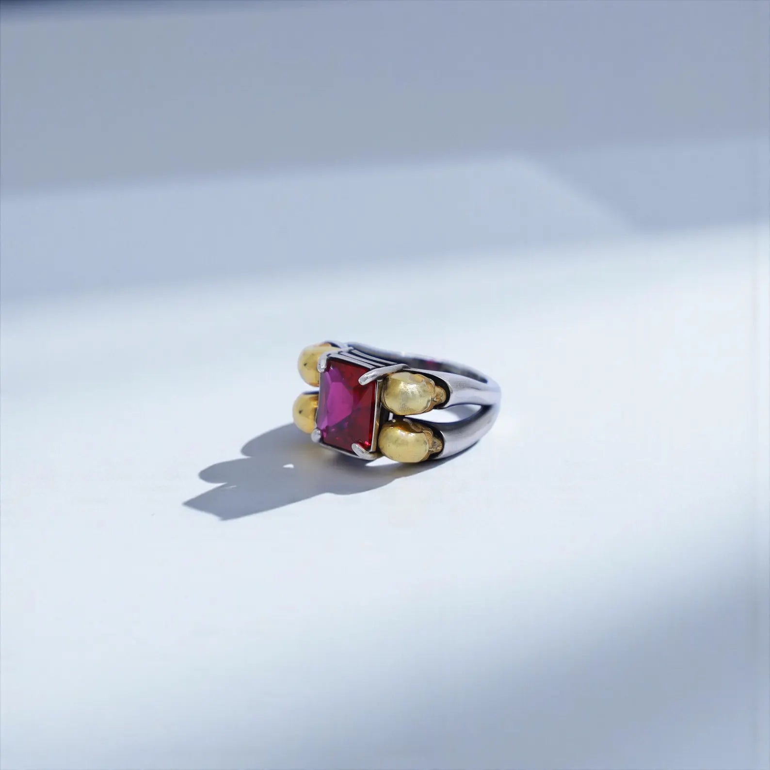 Top-view close-up of a gothic emerald skull ring, crafted from nickel-free sterling silver and featuring handcrafted engravings—SEO for unique gift for him, high-end silver ring, and custom men’s skull ring.