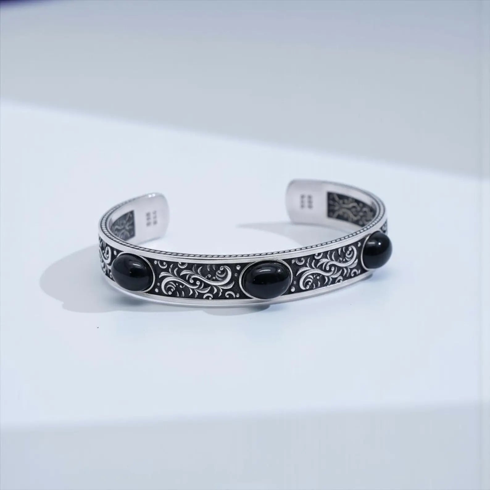 Handcrafted black onyx biker cuff bracelet made from durable 925 sterling silver, featuring bold vintage engravings and three natural onyx stones, designed for men who appreciate unique, masculine, statement jewelry.