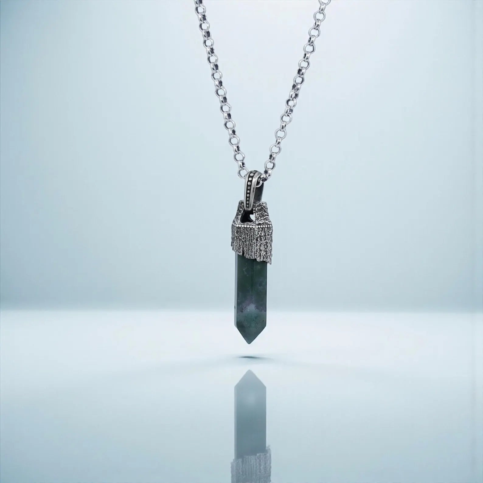 Minimalist yet bold Moss Agate crystal necklace for men, featuring a hand-polished sterling silver compass design with natural gemstone textures, ideal for vintage jewelry lovers and nautical-themed accessories.