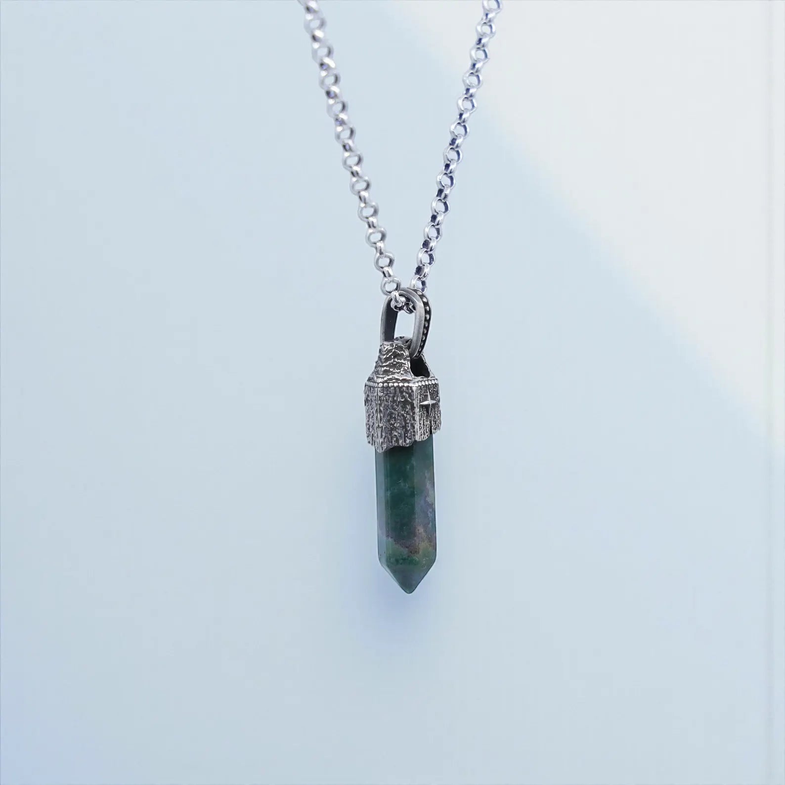 High-resolution product image of men’s Moss Agate necklace with handcrafted sterling silver compass bezel, showcasing earthy gemstone tones and artisan finishing, ideal for gift-inspired
