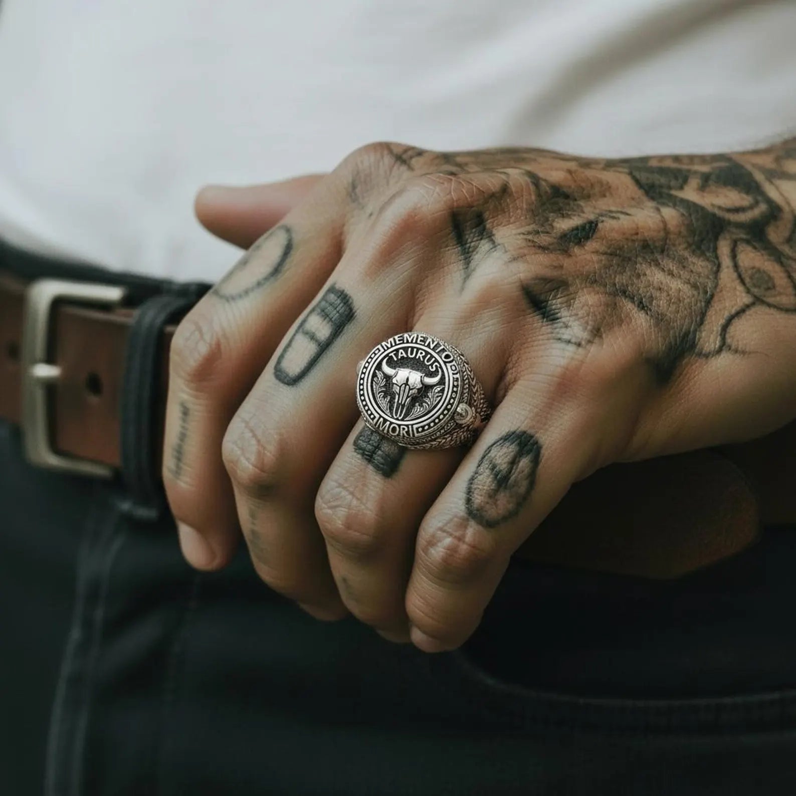 Detailed close-up of a Taurus zodiac bull skull ring in oxidized sterling silver, showcasing intricate handcrafted textures, gothic symbolism, and a powerful masculine signet ring design.