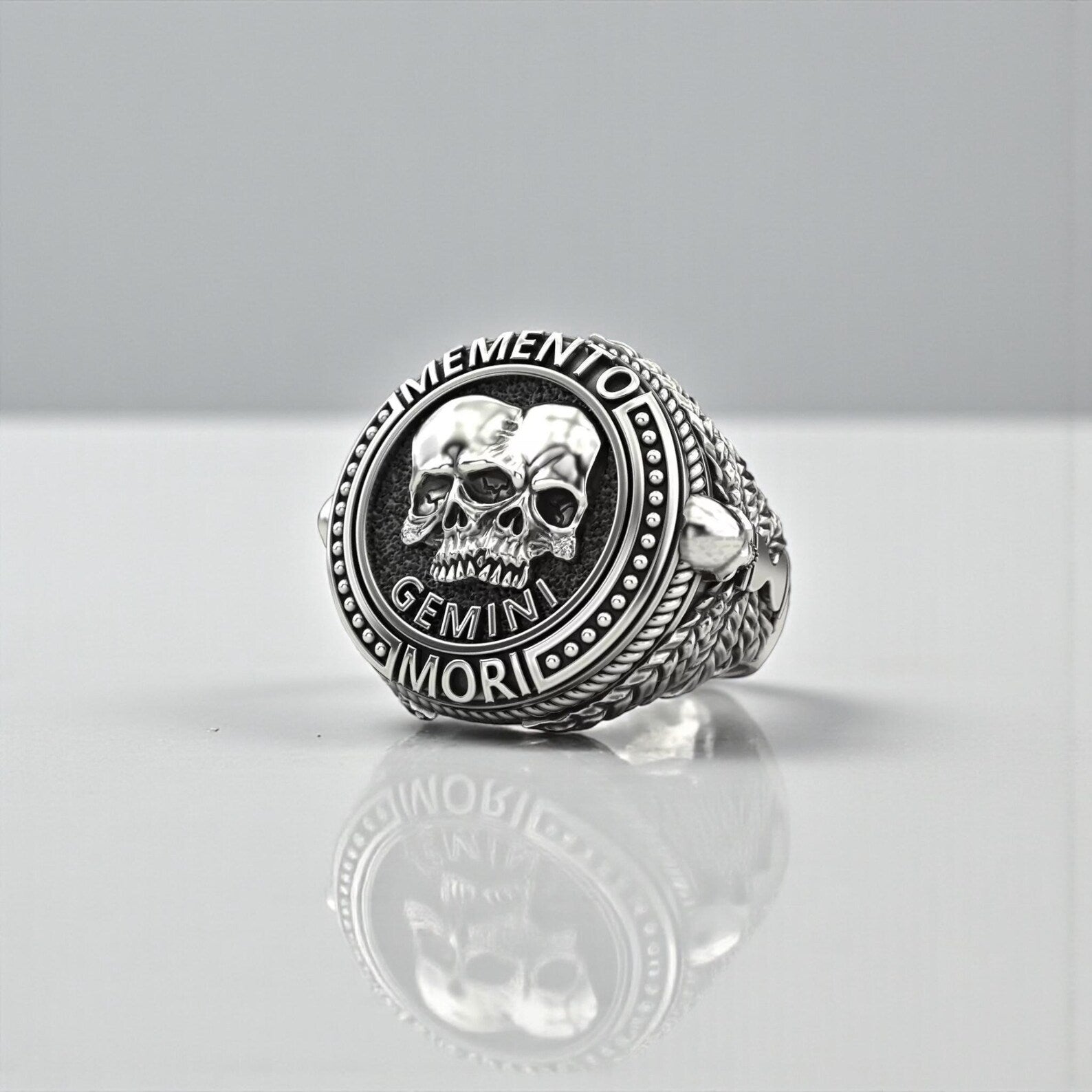 Handcrafted 925 sterling silver Gemini Skull Ring featuring an intricate twin-skull Memento Mori design, symbolizing duality, transformation, and zodiac energy, with deeply oxidized details and premium gothic craftsmanship for men who appreciate bold and meaningful jewelry.