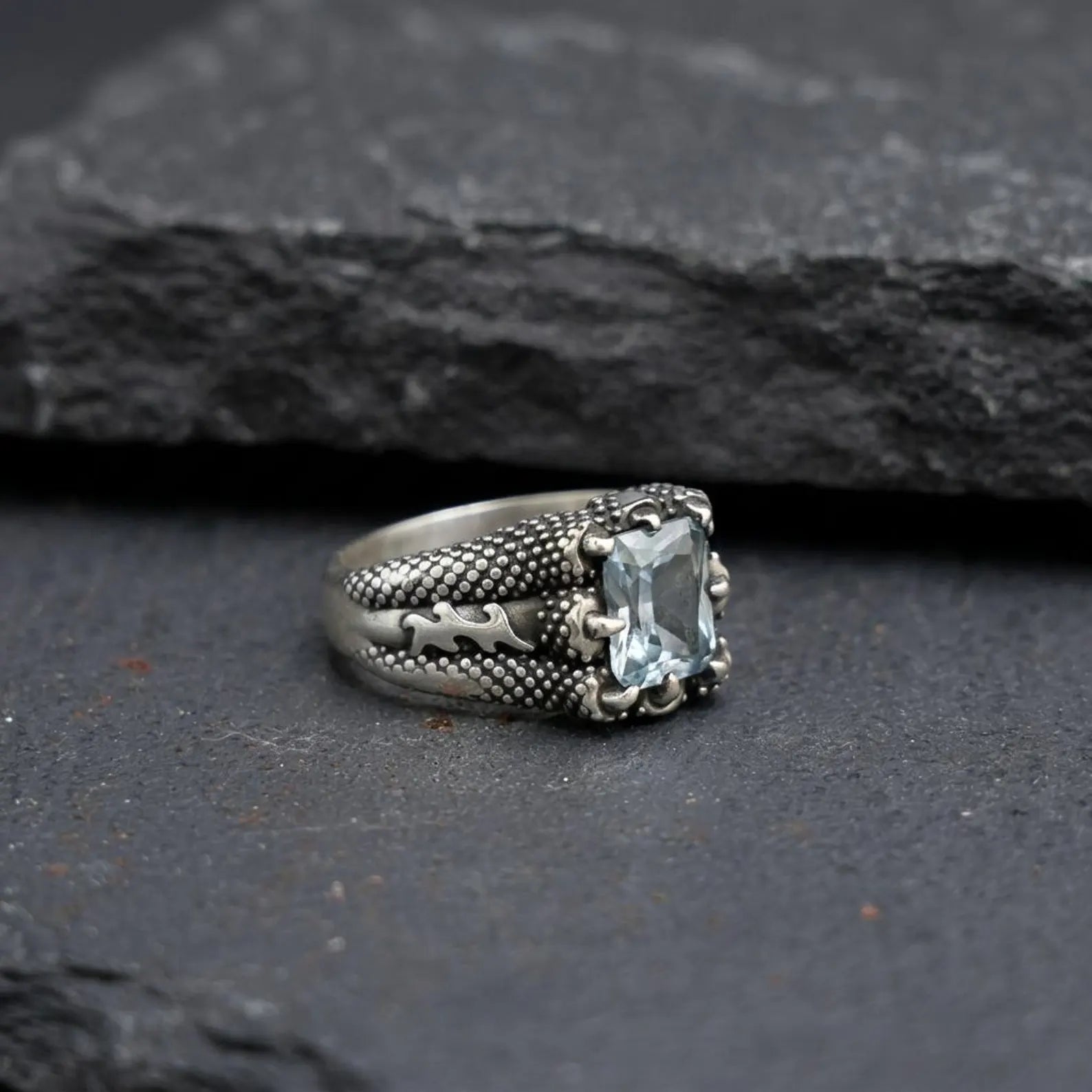Men’s aquamarine gemstone ring with a bold sterling silver claw frame, designed to highlight the calming and protective qualities of the natural birthstone.