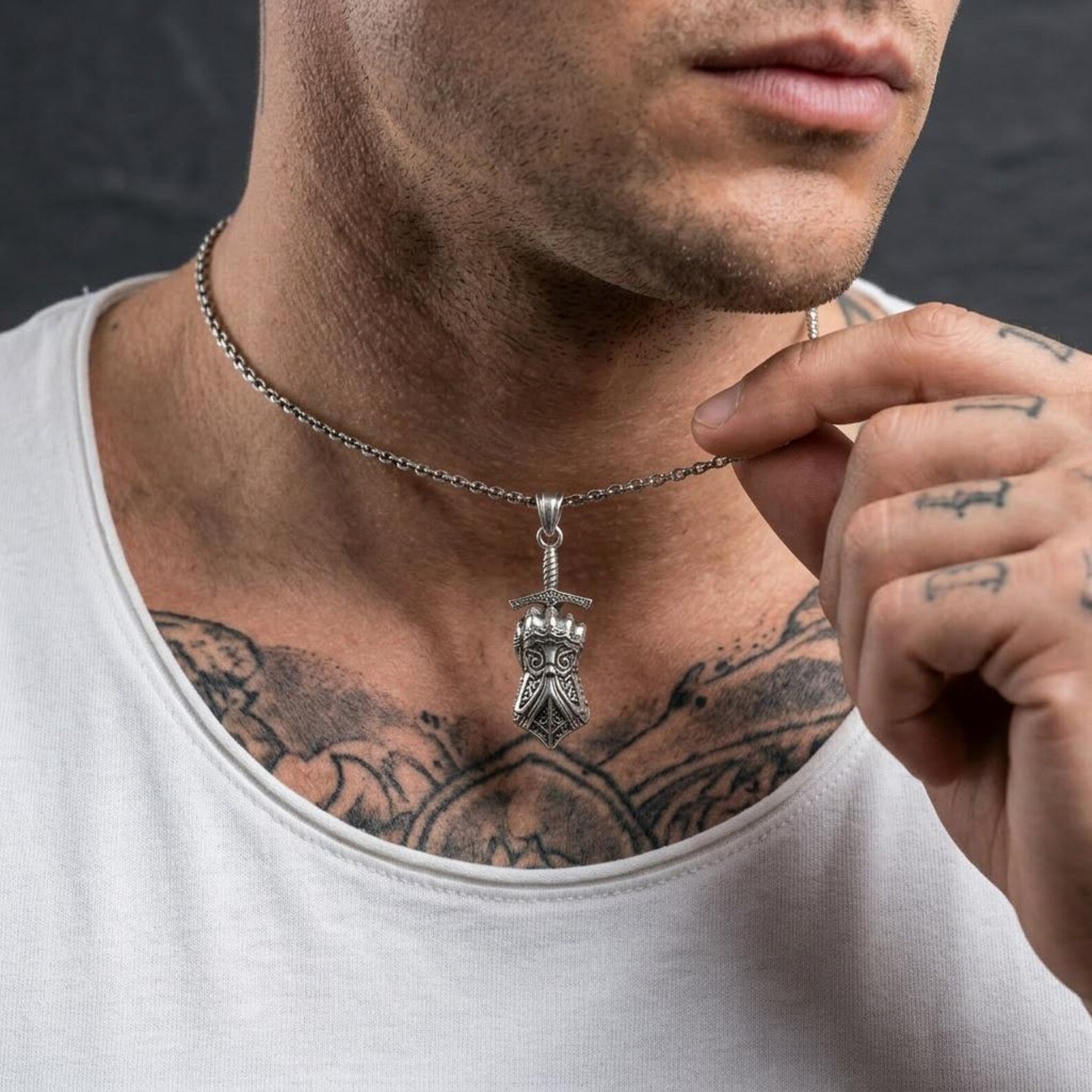 Sterling silver knight gauntlet necklace for men with intricate medieval armor detailing, handcrafted fantasy jewelry inspired by warriors and knights, bold symbolic accessory representing courage and honor