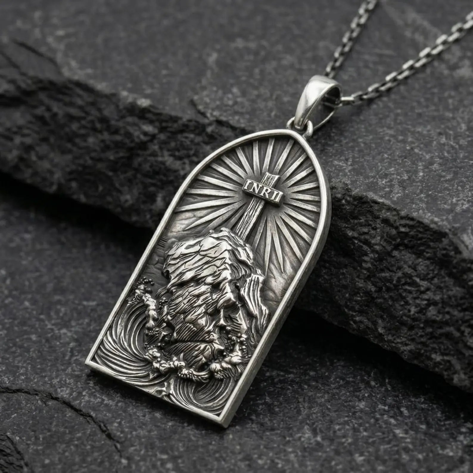 Detailed INRI cross necklace reflecting polished and oxidized finish, symbolizing sacrifice, belief, and divine protection