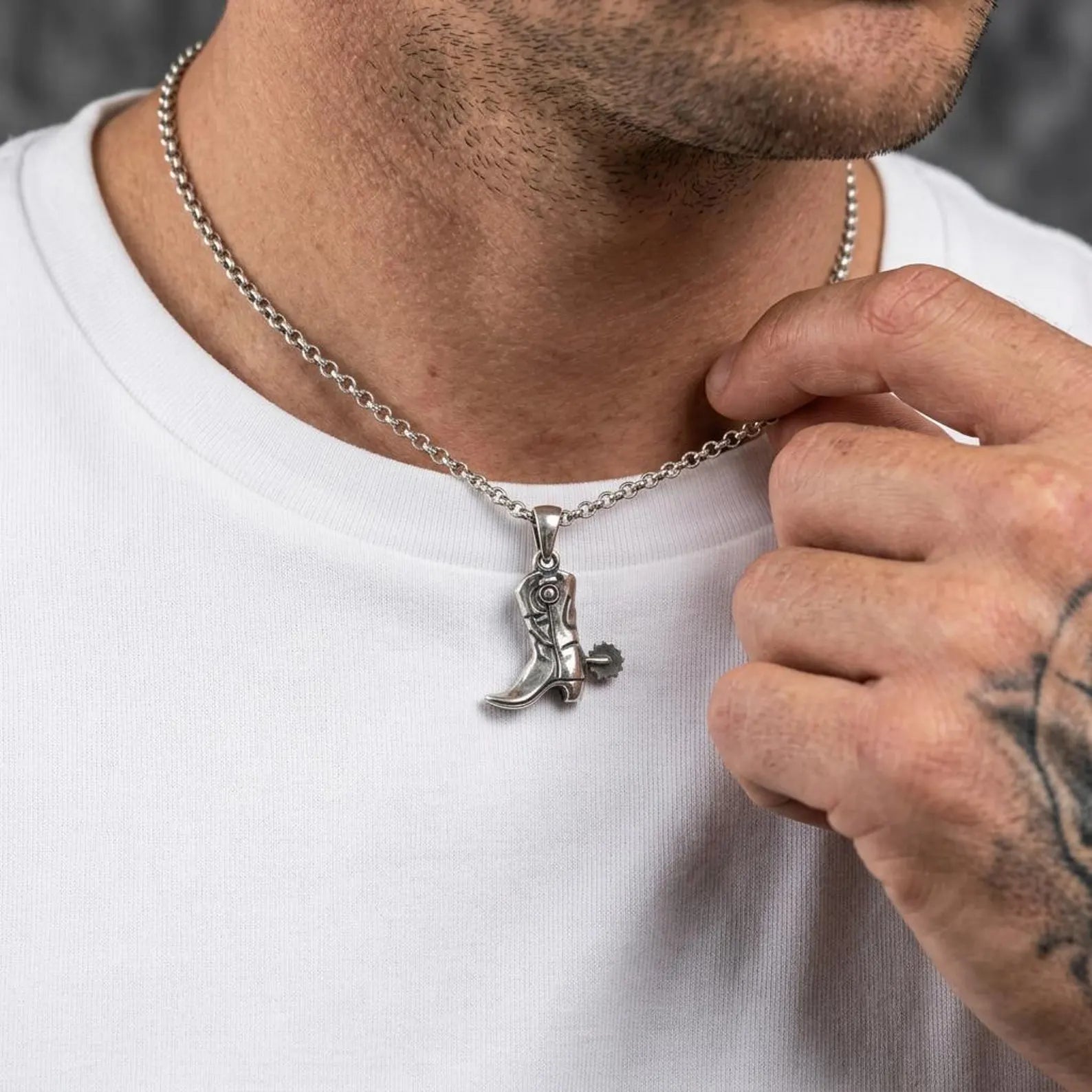 Detailed cowboy boot necklace pendant featuring vintage western craftsmanship and oxidized sterling silver finish.