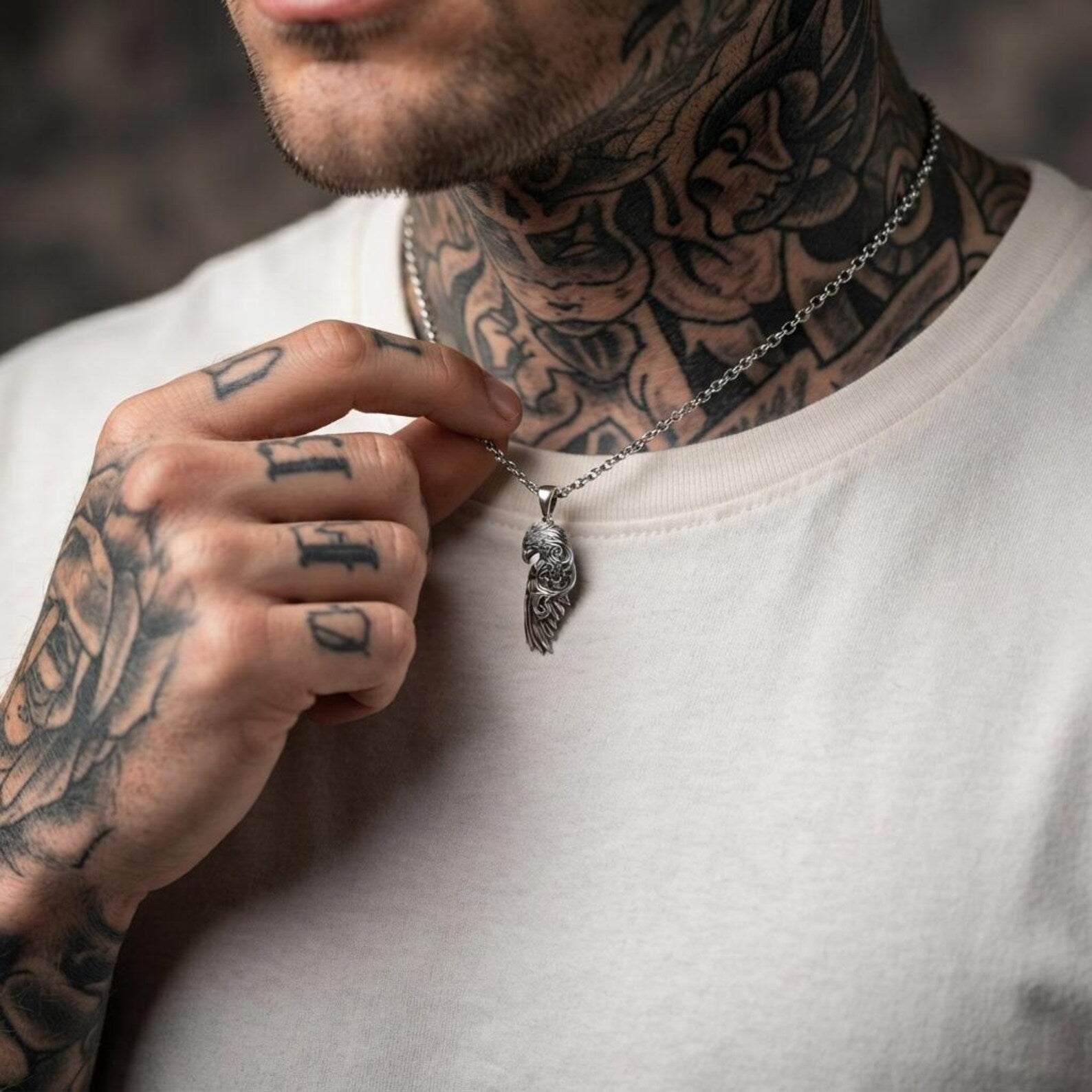 Close-up view of a handcrafted 925 sterling silver Raven Wing pendant showcasing beautifully sculpted feathers, elegant Baroque ornamentation, oxidized vintage detailing, and exceptional artisan craftsmanship inspired by Odin and ancient mythology.