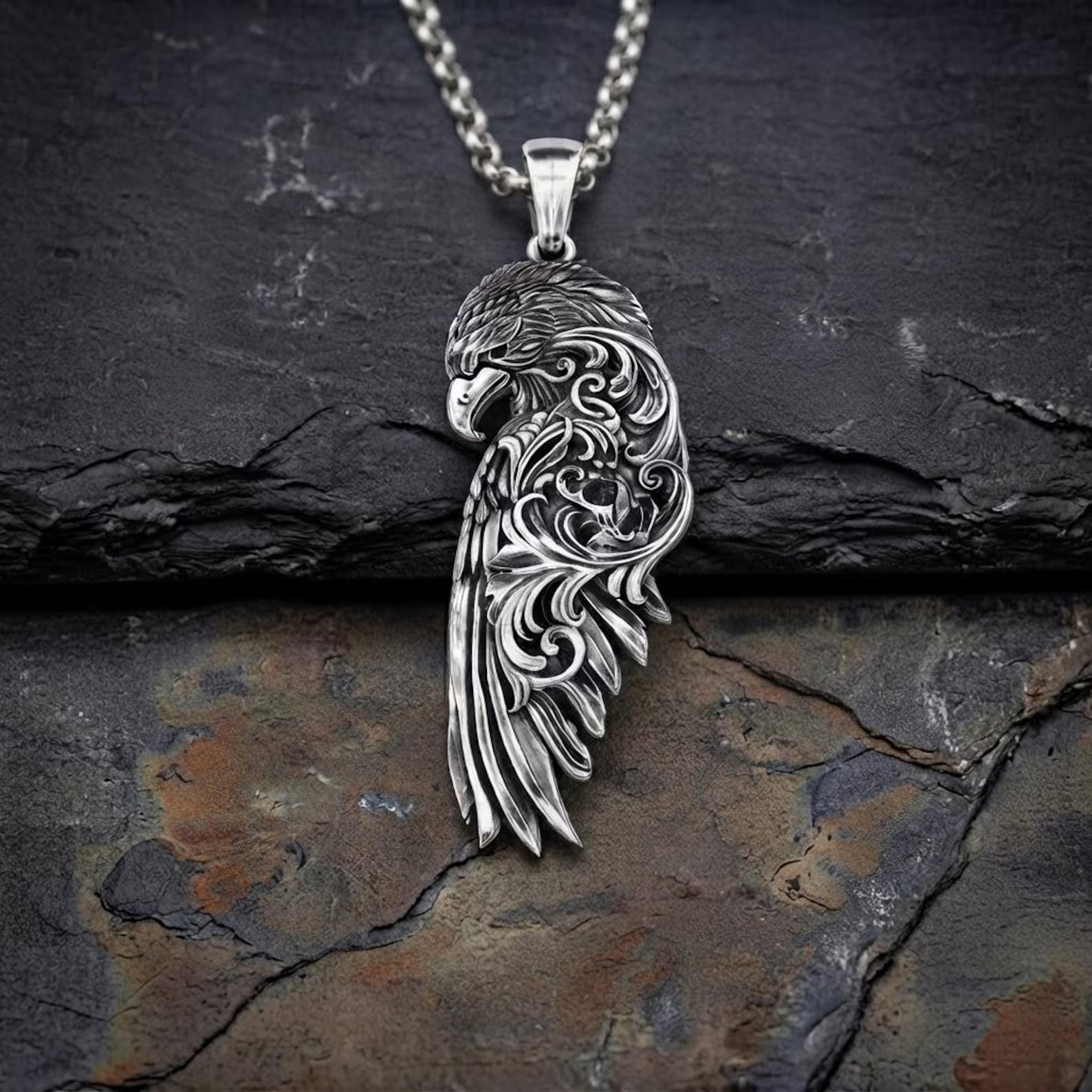 Handcrafted sterling silver Raven Wing pendant necklace featuring intricate Baroque-inspired engravings, detailed feather textures, and an oxidized antique finish, symbolizing wisdom, transformation, protection, and the legendary spirit of Norse mythology.