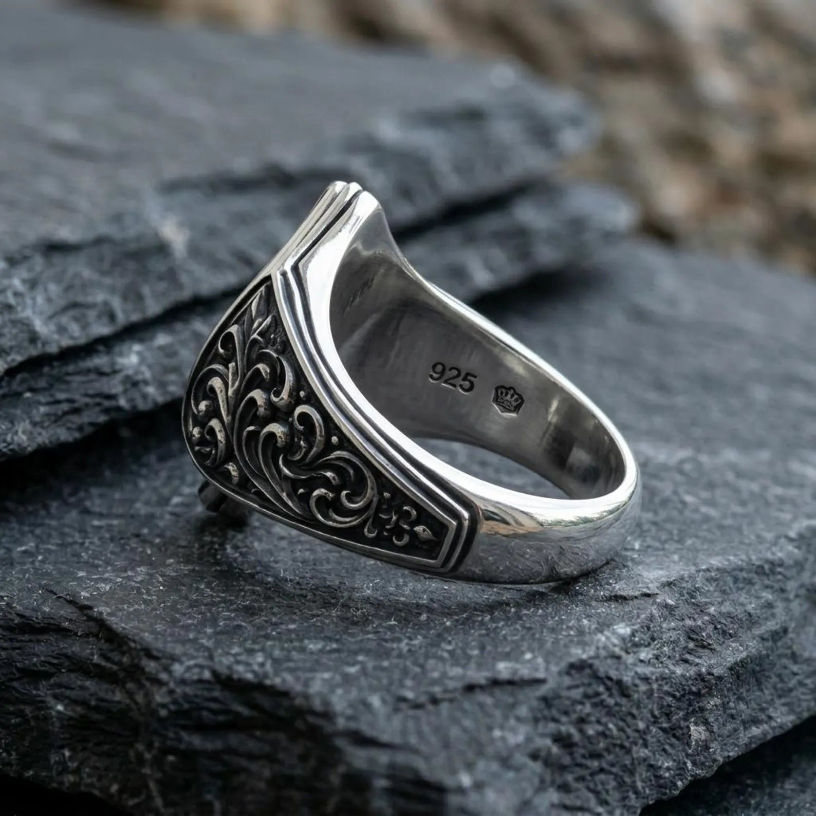 Detailed view of a handcrafted sterling silver signet ring featuring a Gothic Ace of Spades motif, engraved medieval scrollwork, oxidized vintage finish, and exceptional craftsmanship that blends poker symbolism with timeless masculine style.