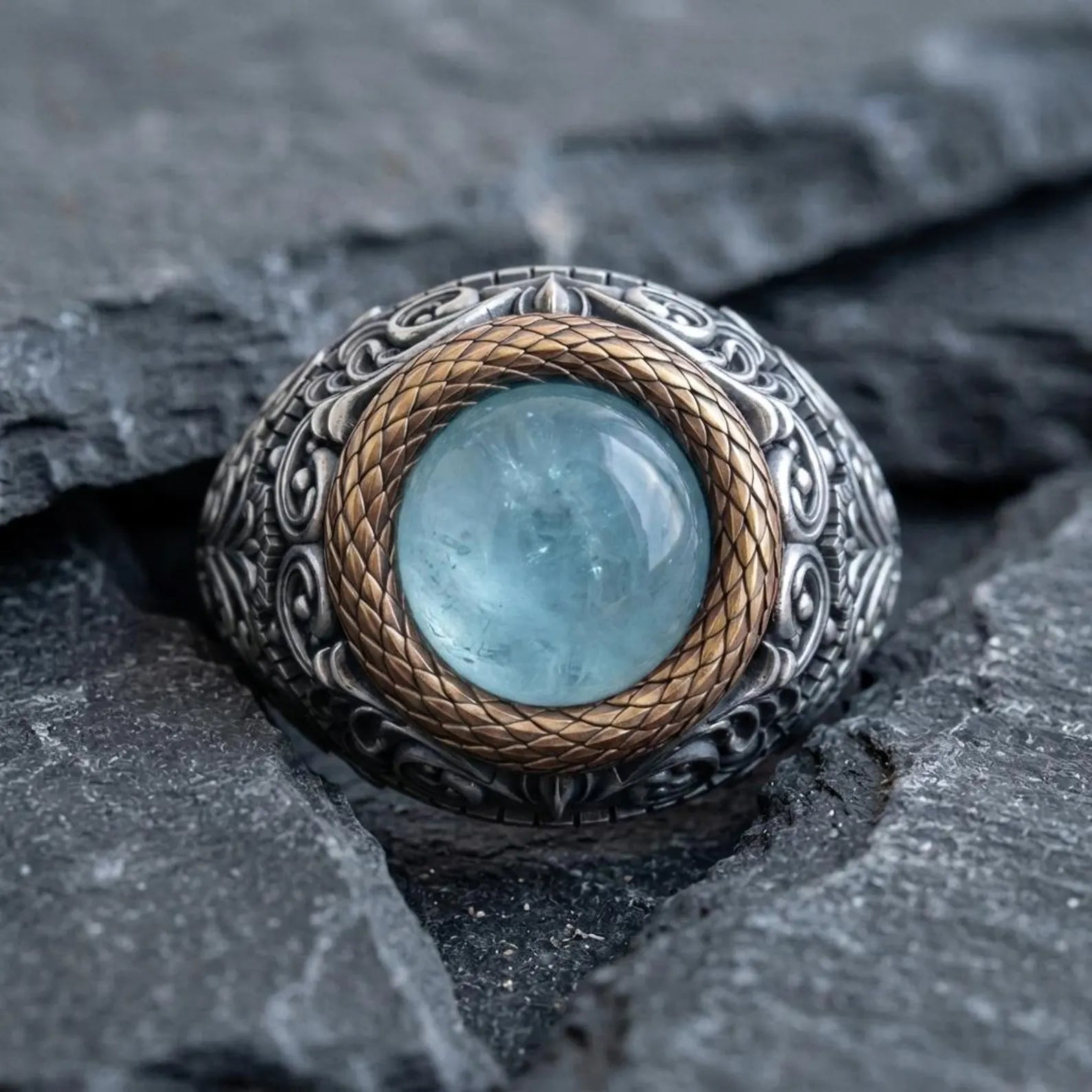Unique sterling silver aquamarine signet ring for men with ornate Victorian engravings and a polished natural round aquamarine cabochon centerpiece.