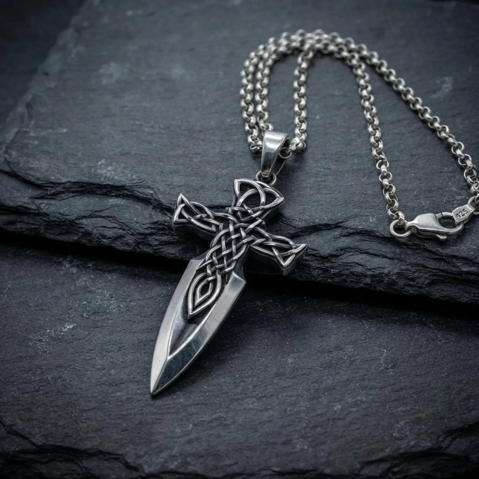 Handmade sterling silver Christian Cross Sword necklace with traditional Celtic knot patterns, inspired by medieval knights and ancient Irish artistry, creating a bold statement piece for collectors and believers.