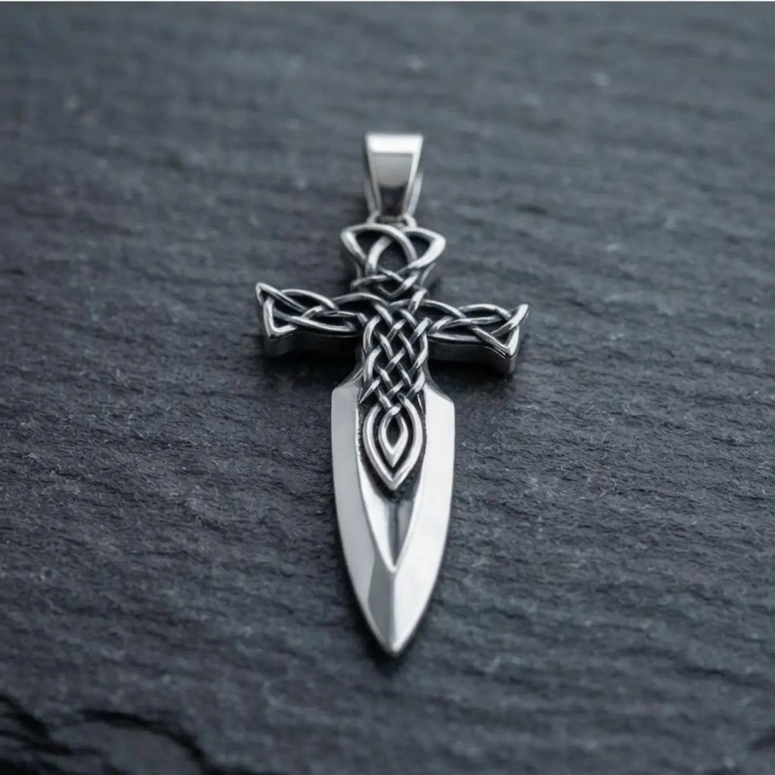 Sterling silver medieval sword cross pendant necklace with detailed Celtic artwork, handcrafted to represent courage, honor, eternal life, and the enduring connection between faith and Celtic tradition.