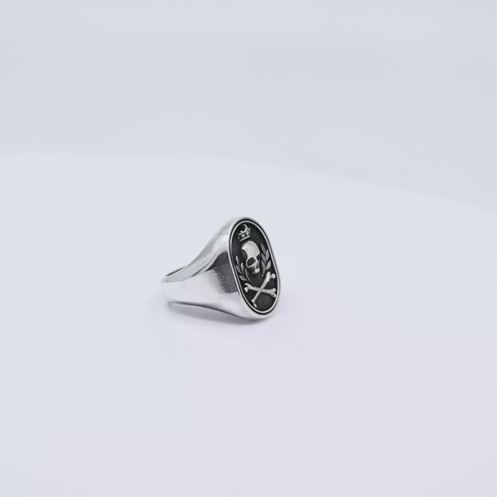Handcrafted skull signet ring for men made from solid 925 sterling silver, designed with gothic crossbone motifs and a royal crown above the skull, symbolizing rebellion, strength, and timeless masculine elegance.