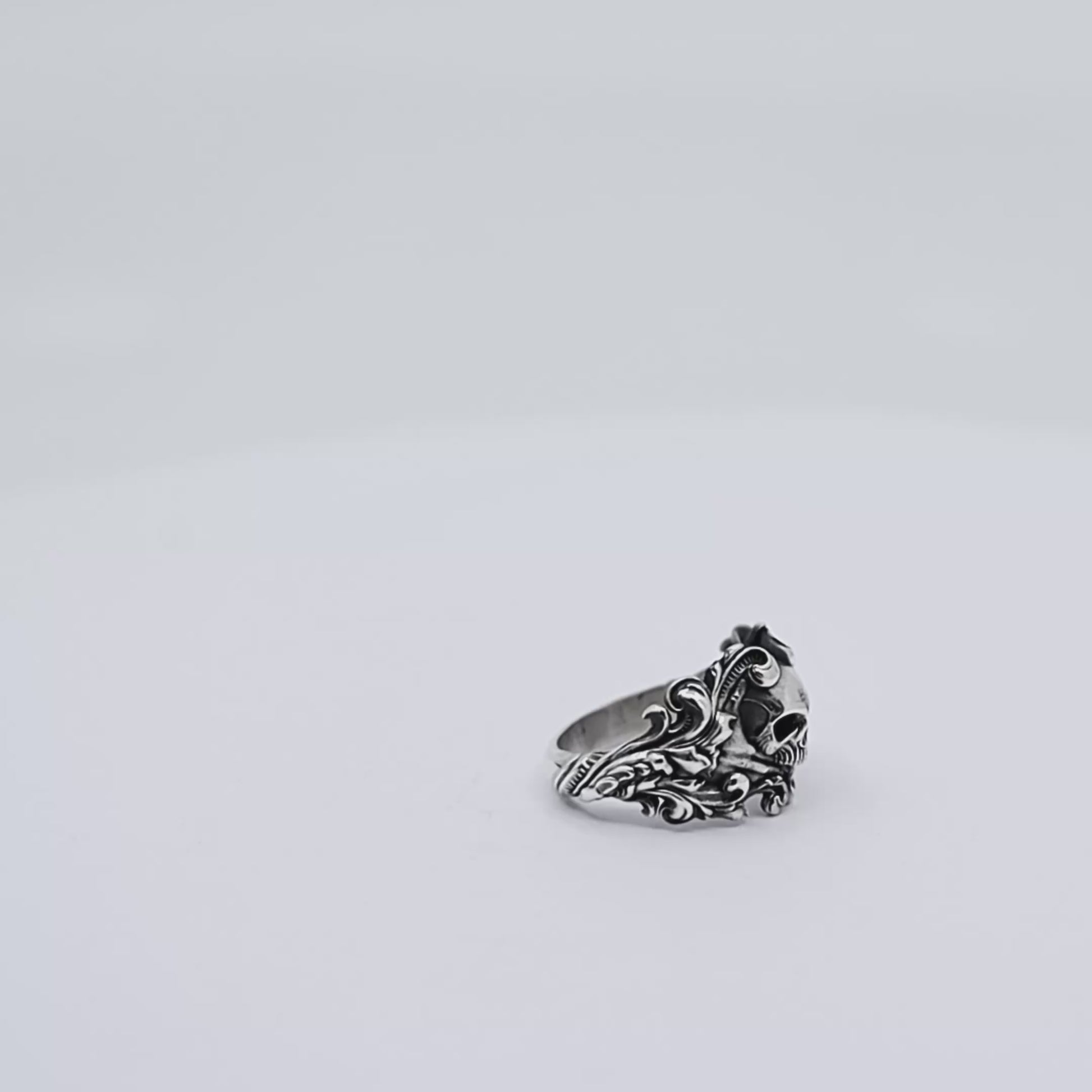 Sterling silver skull ring for men, combining gothic biker style with elegant baroque motifs carved around the band, making it a powerful statement piece for those who embrace dark, detailed, and artistic jewelry.