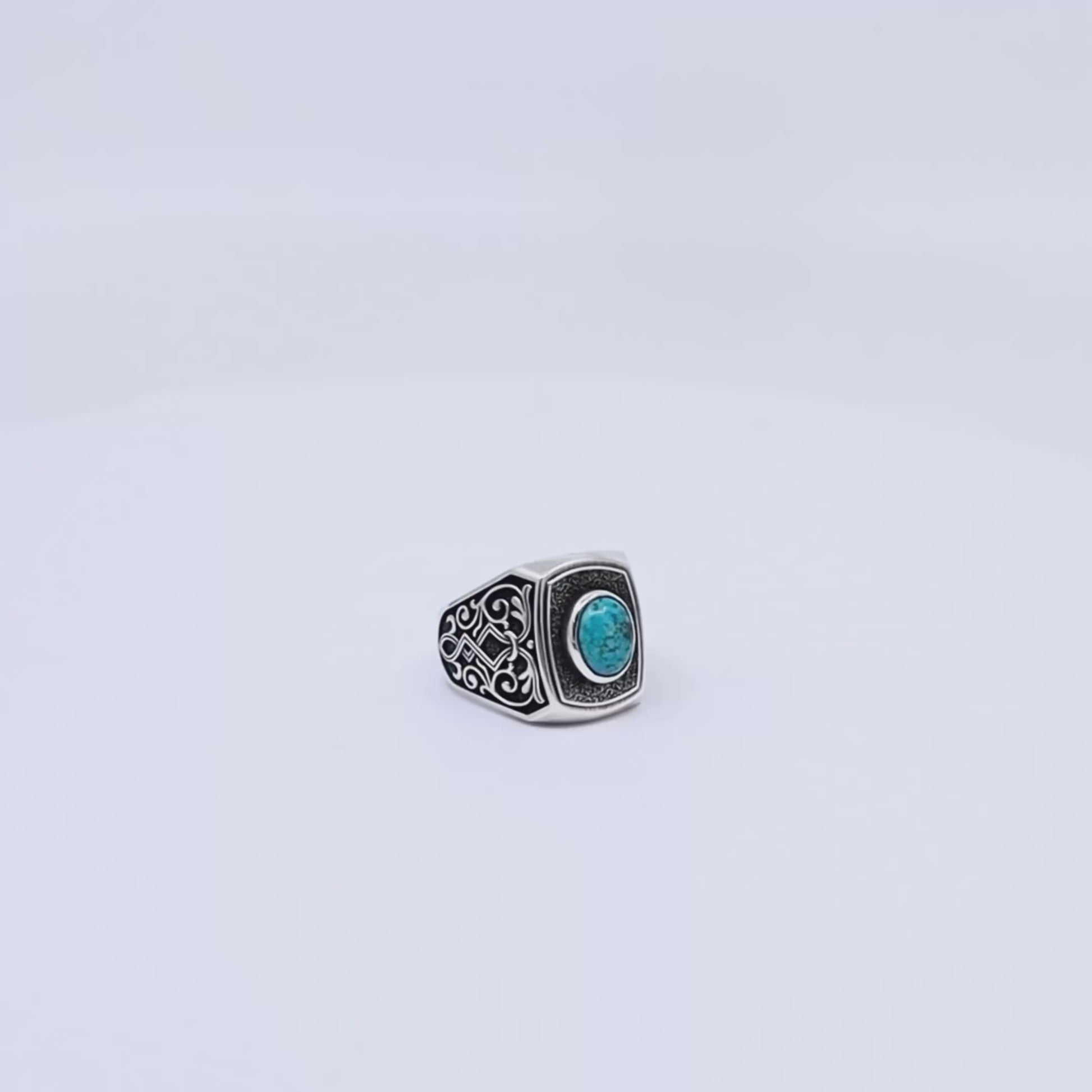 Sterling silver gothic ring for men with an oval turquoise gemstone centerpiece, handcrafted with dark oxidized details and a rugged design that blends mysticism, style, and strength.