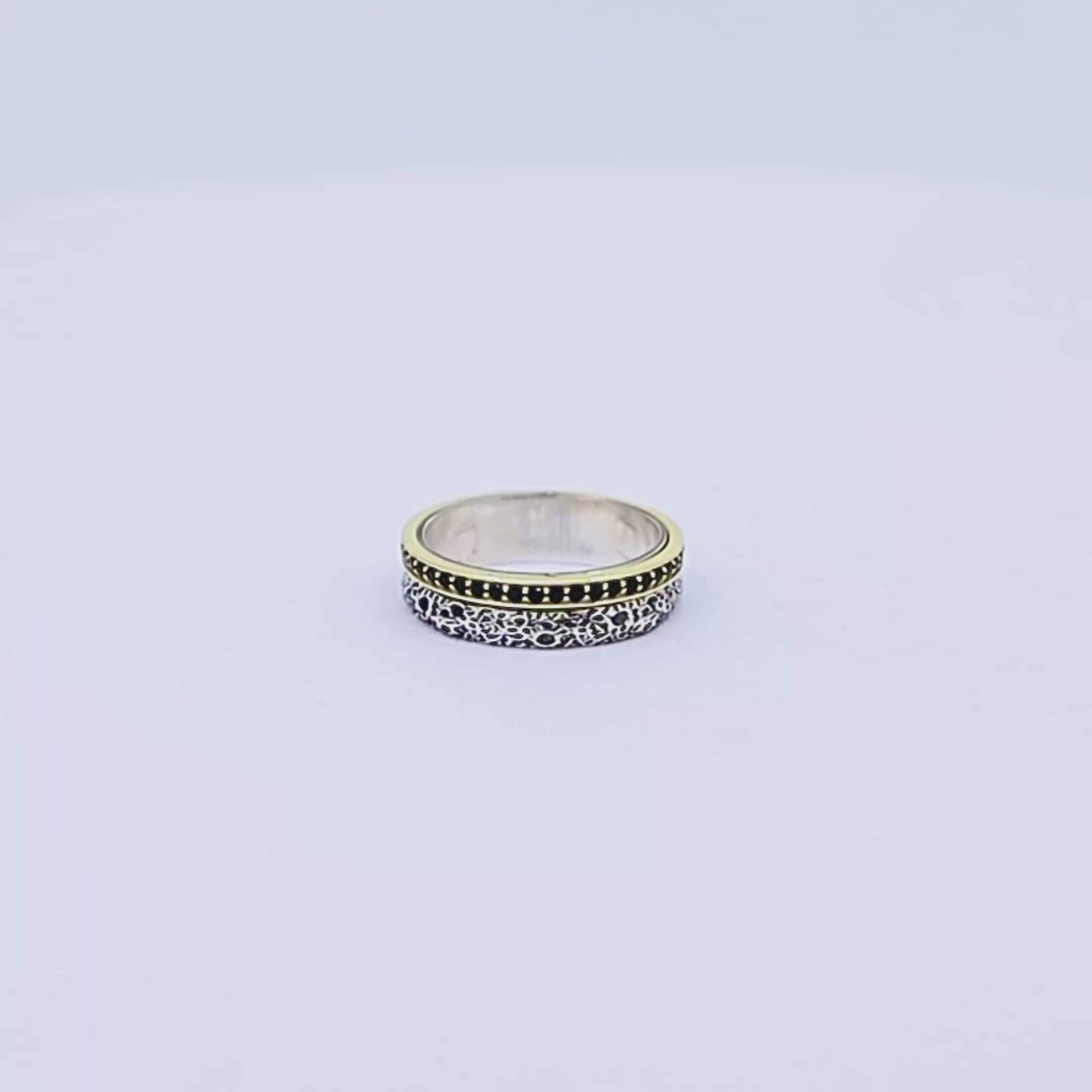 Elegant pair of handcrafted wedding bands made from 925 sterling silver and highlighted with gold plating, showcasing a rustic texture and personalized engraving, ideal for couples seeking unique, artisanal rings for their special day.