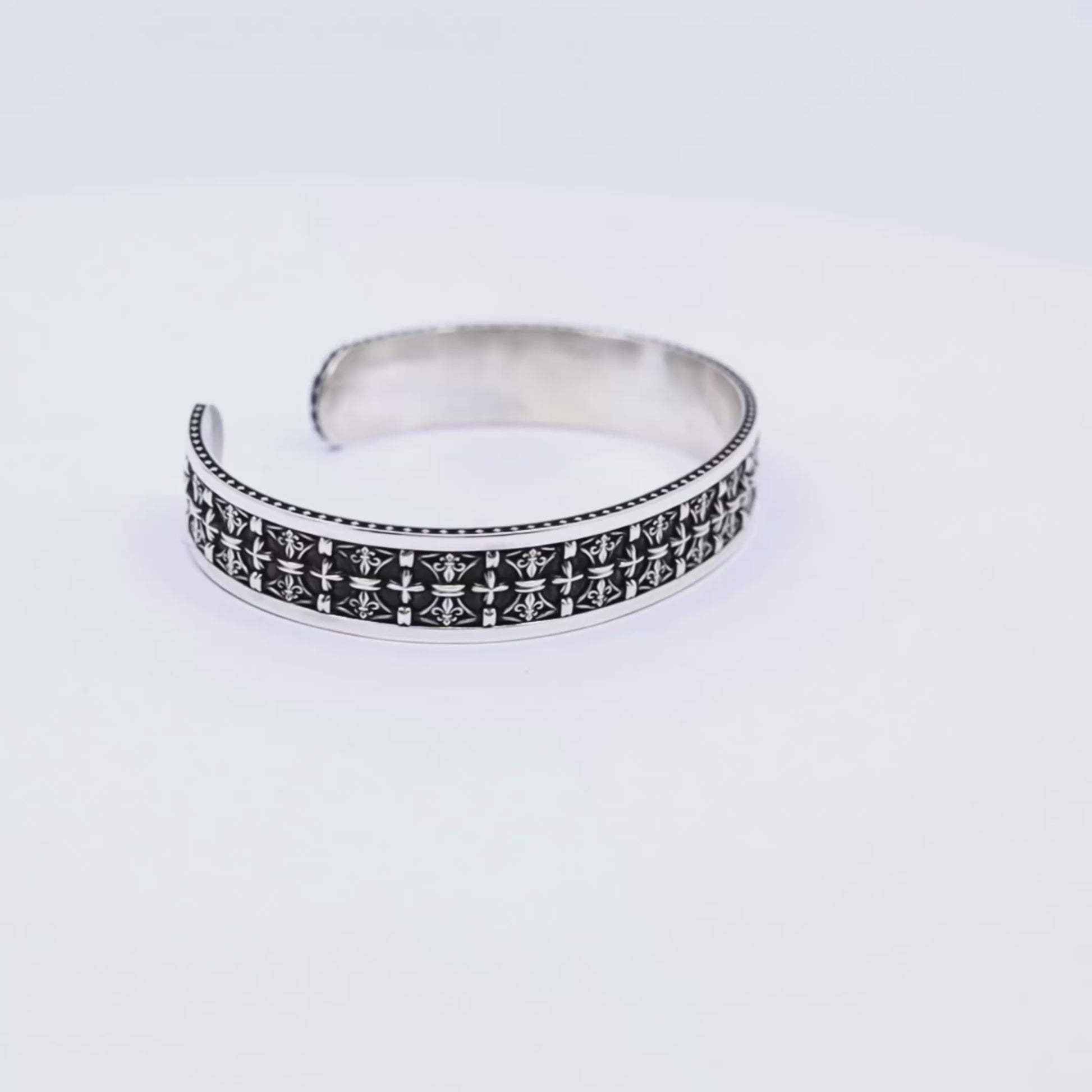 Intricately detailed men's sterling silver gothic cuff bracelet featuring repeated engraved crosses and a textured antique finish. Handmade with precision, this statement piece symbolizes strength and spirituality—ideal for those who resonate with religious symbolism and gothic fashion. Suitable as a meaningful gift for husbands, boyfriends, or sons.
